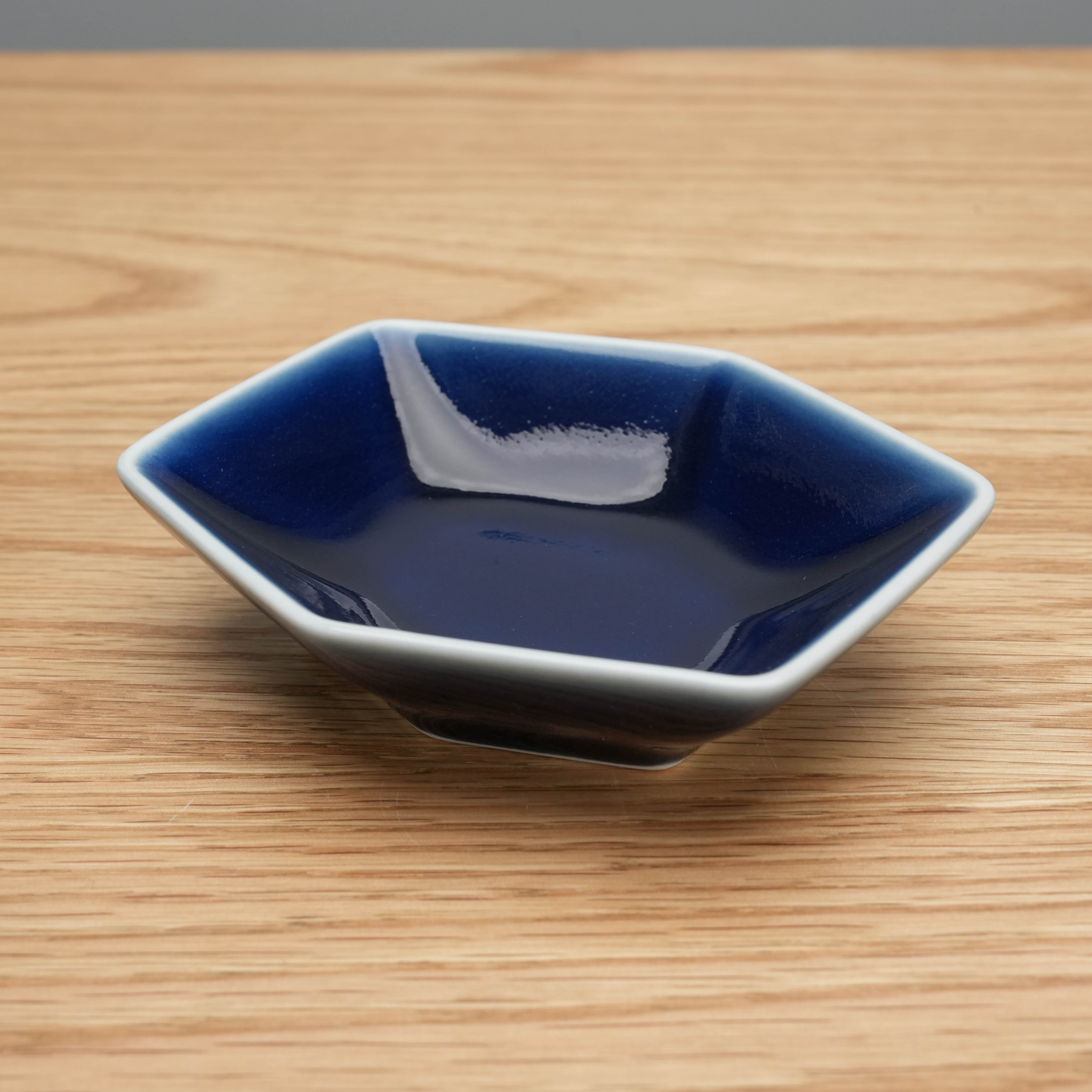 Navy blue Hakusan Kikkou Sauce Dish with glossy finish and hexagonal tortoiseshell design, perfect for versatile kitchen use.