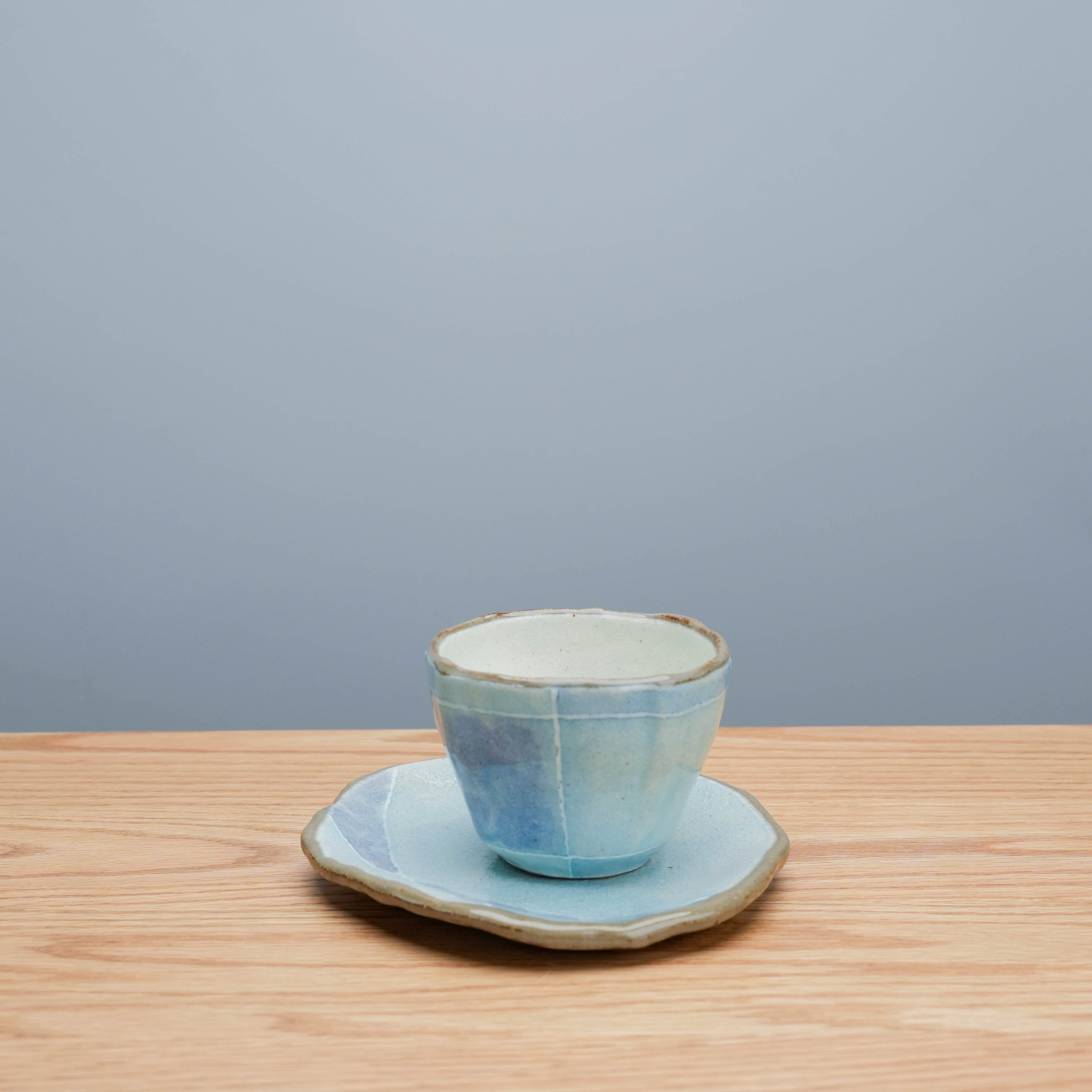 Side view of Tokiwa Mino Ware Cup & Saucer - Coffee Cup with Saucer | Handmade Japanese blue ceramic set with artisanal finish and soft curves.