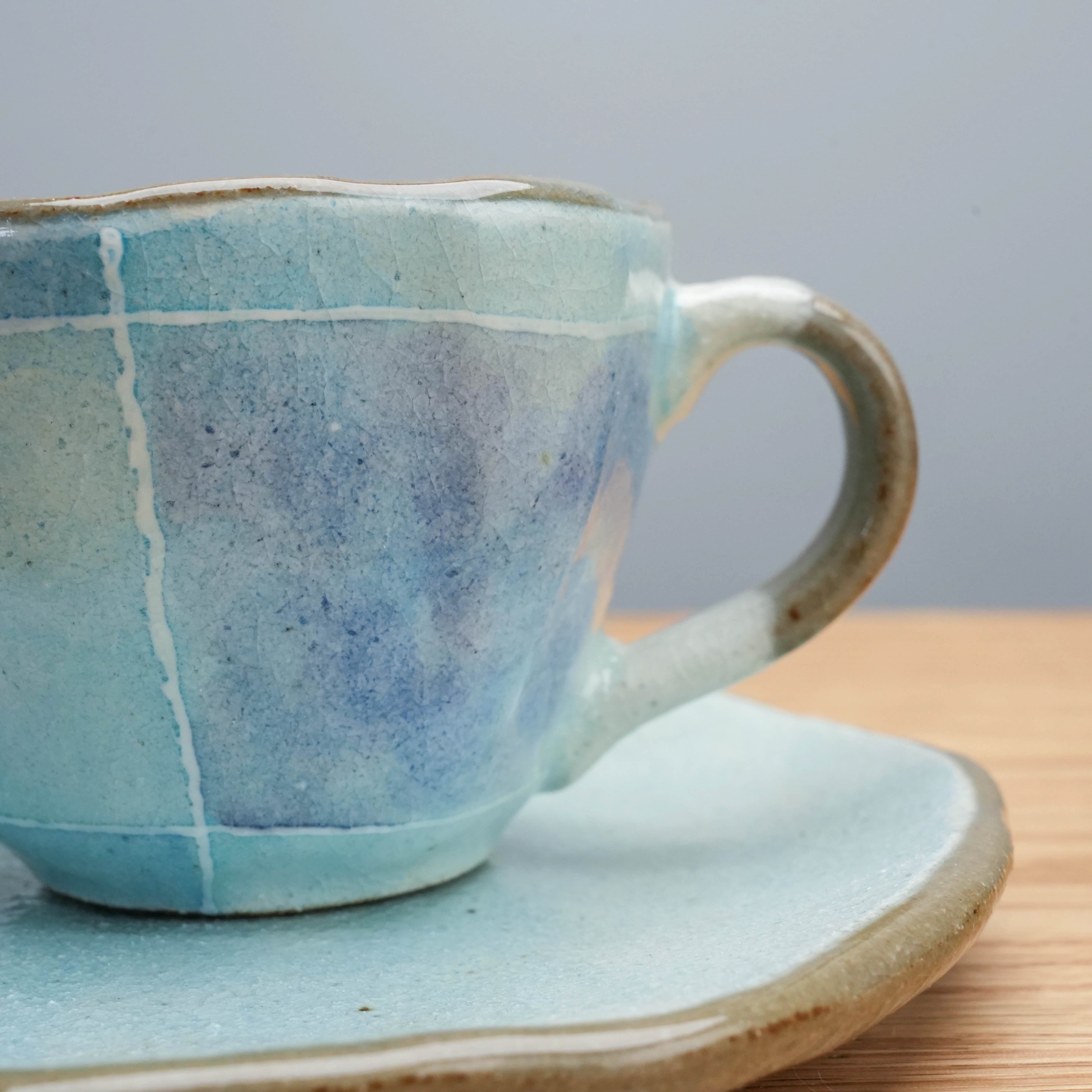 Close-up of Tokiwa Mino Ware Cup & Saucer - Coffee Cup with Saucer | Handmade handle and textured blue glaze detail on Japanese ceramic cup.