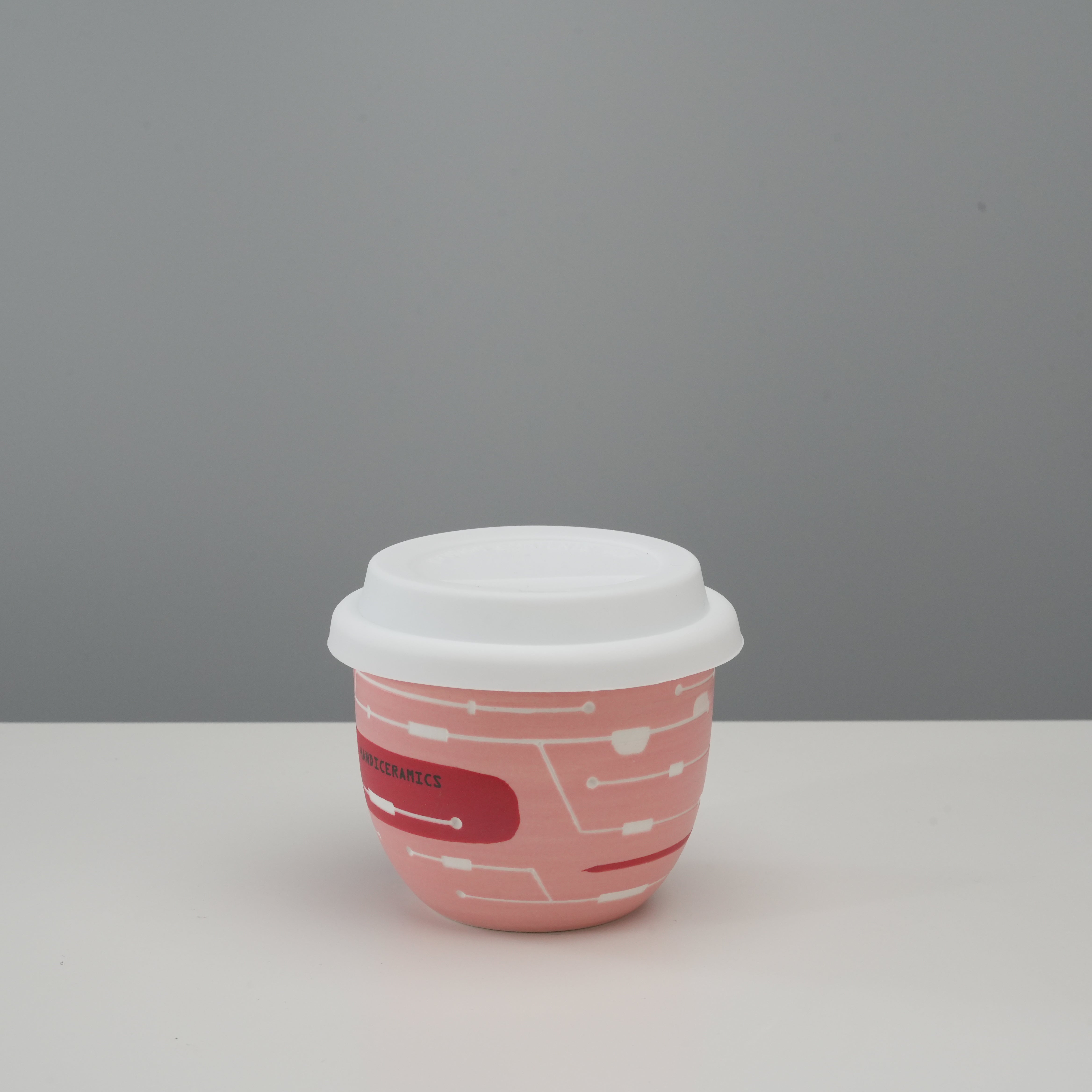 Handiceramics Travel Cup - Ceramic Coffee Cup with Lid in Dragonfruit color, featuring a pink porcelain body and white silicone lid.