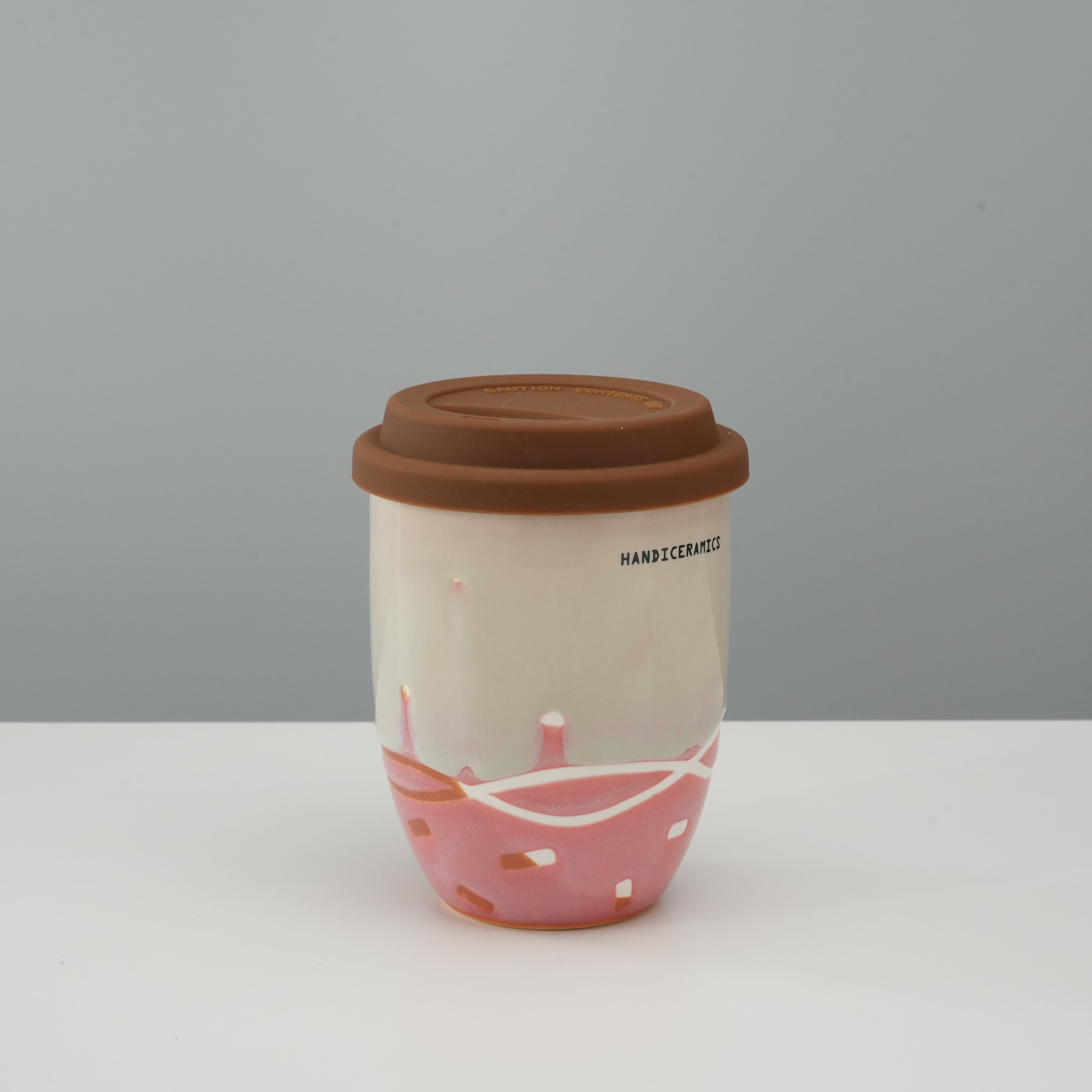 Tall version of Handiceramics Travel Cup - Ceramic Coffee Cup with Lid in strawberry pink, perfect for coffee or tea lovers on the move.