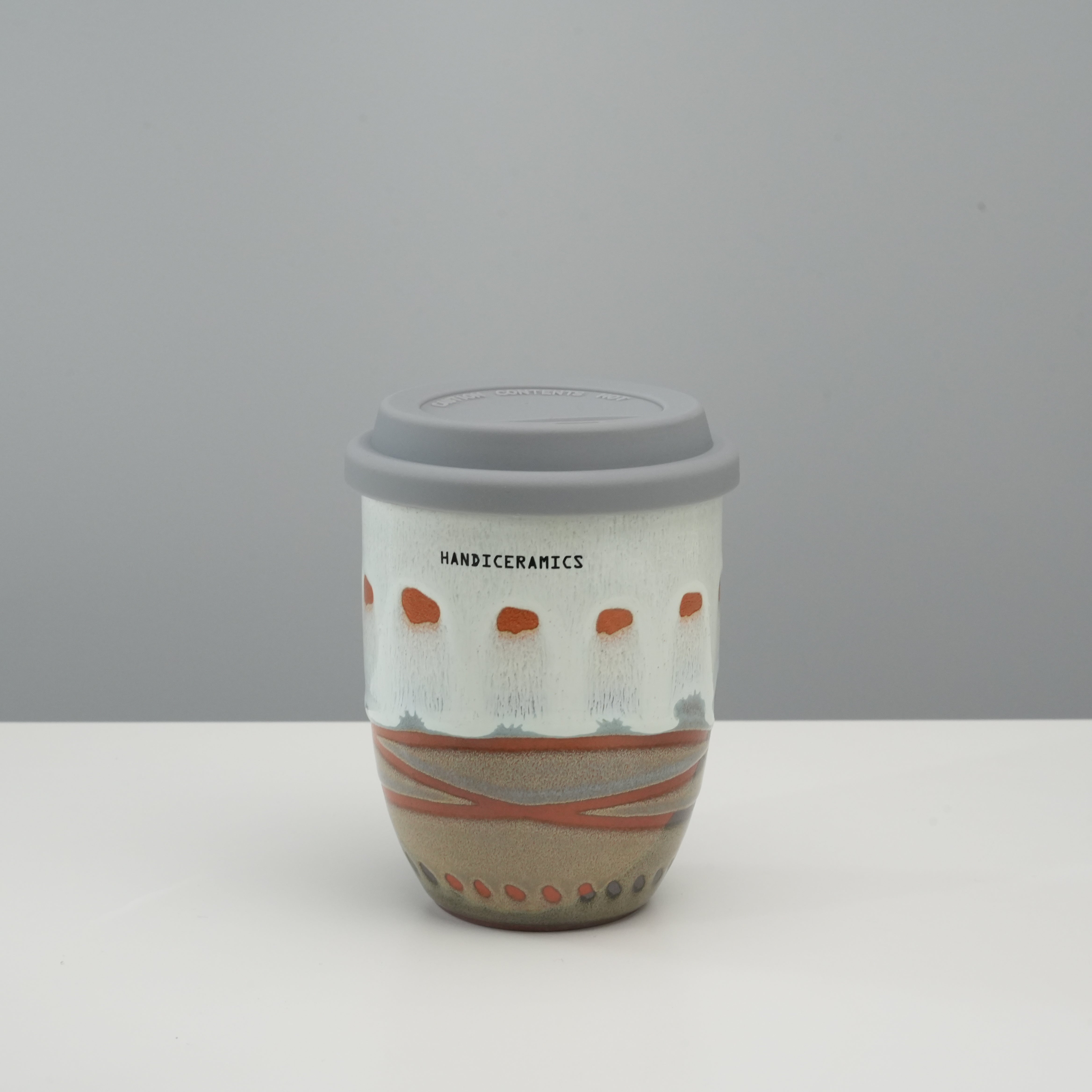 Tall version of Handiceramics Travel Cup - Ceramic Coffee Cup with Lid in Sesame, with hand-painted detailing and ergonomic design.