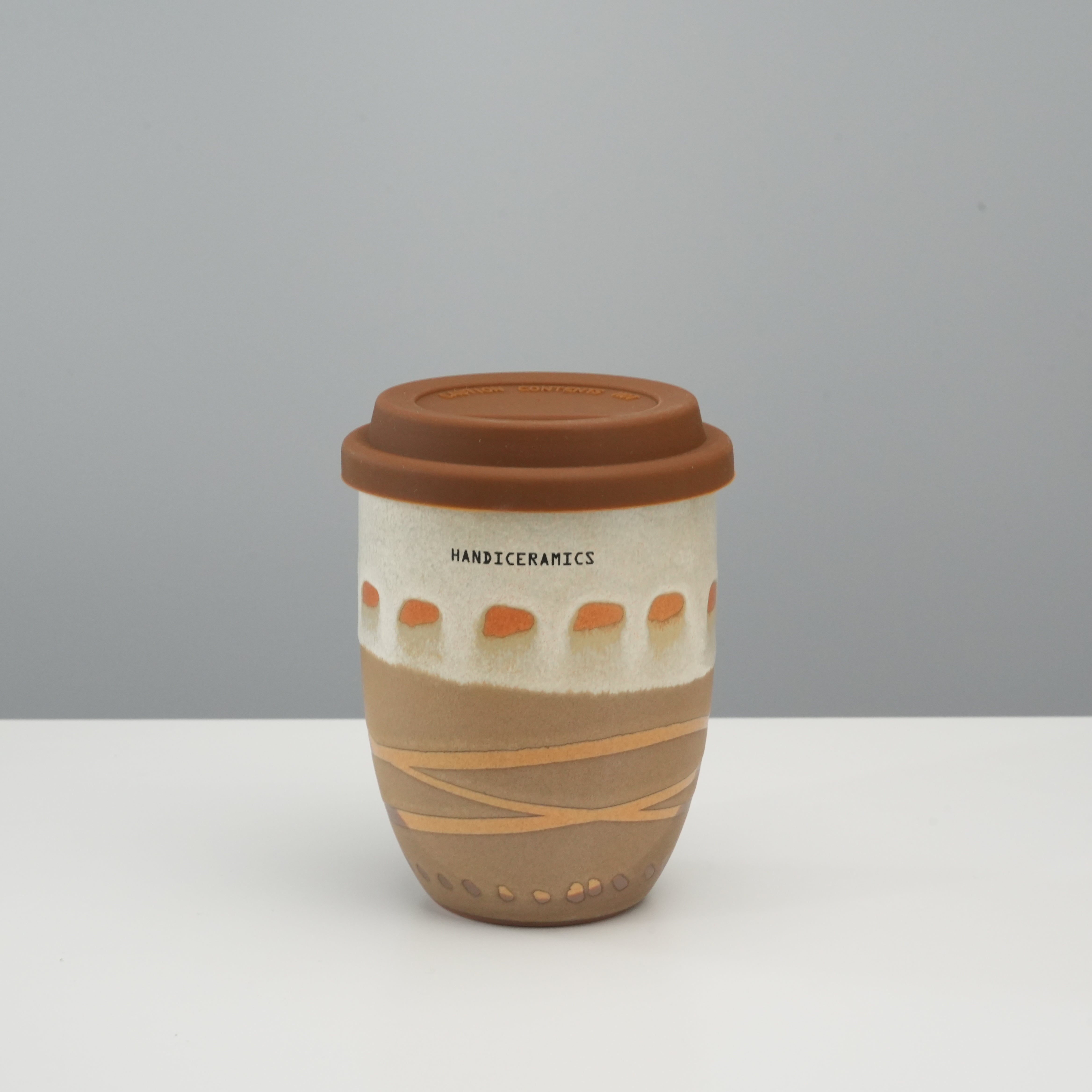 Tall Handiceramics Travel Cup - Ceramic Coffee Cup with Lid in mocha, featuring earthy tones and hand-painted acorn motif.