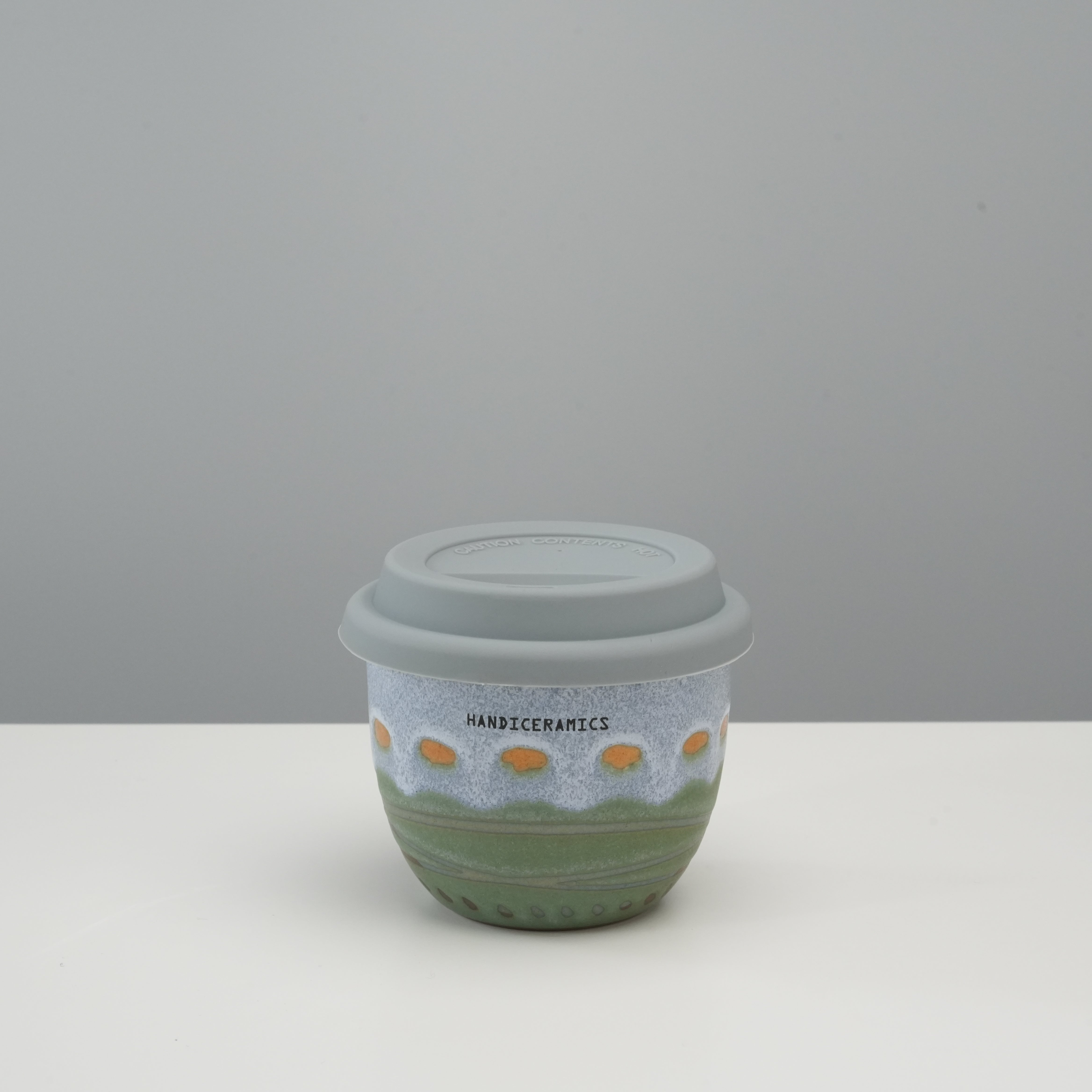 Handiceramics Travel Cup - Ceramic Coffee Cup with Lid | Palm Beach design featuring a compact acorn shape and silicone lid for easy travel use.
