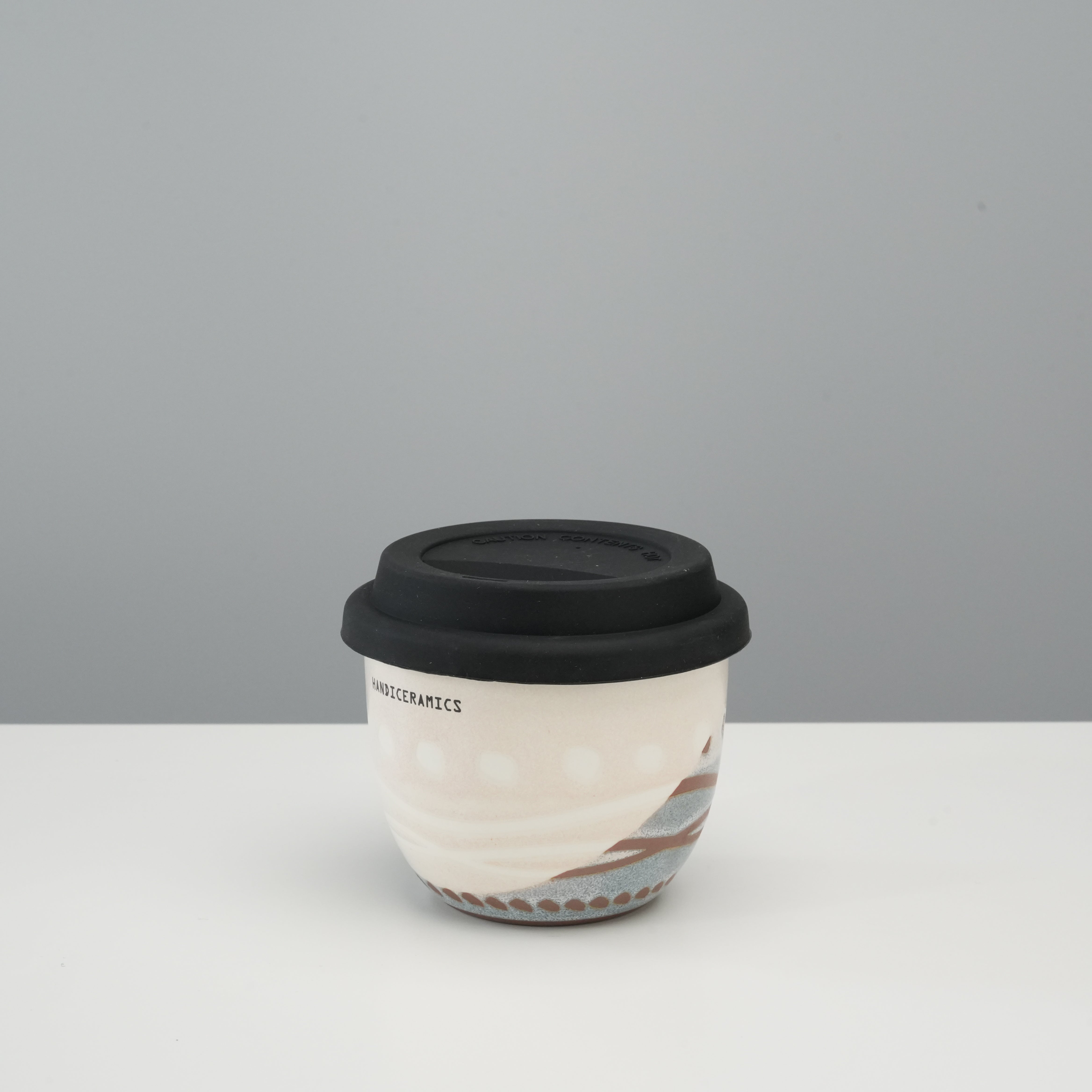 Handiceramics Travel Cup - Ceramic Coffee Cup with Lid in Marshmallow color, featuring a handmade acorn shape and black silicone lid for stylish sipping.