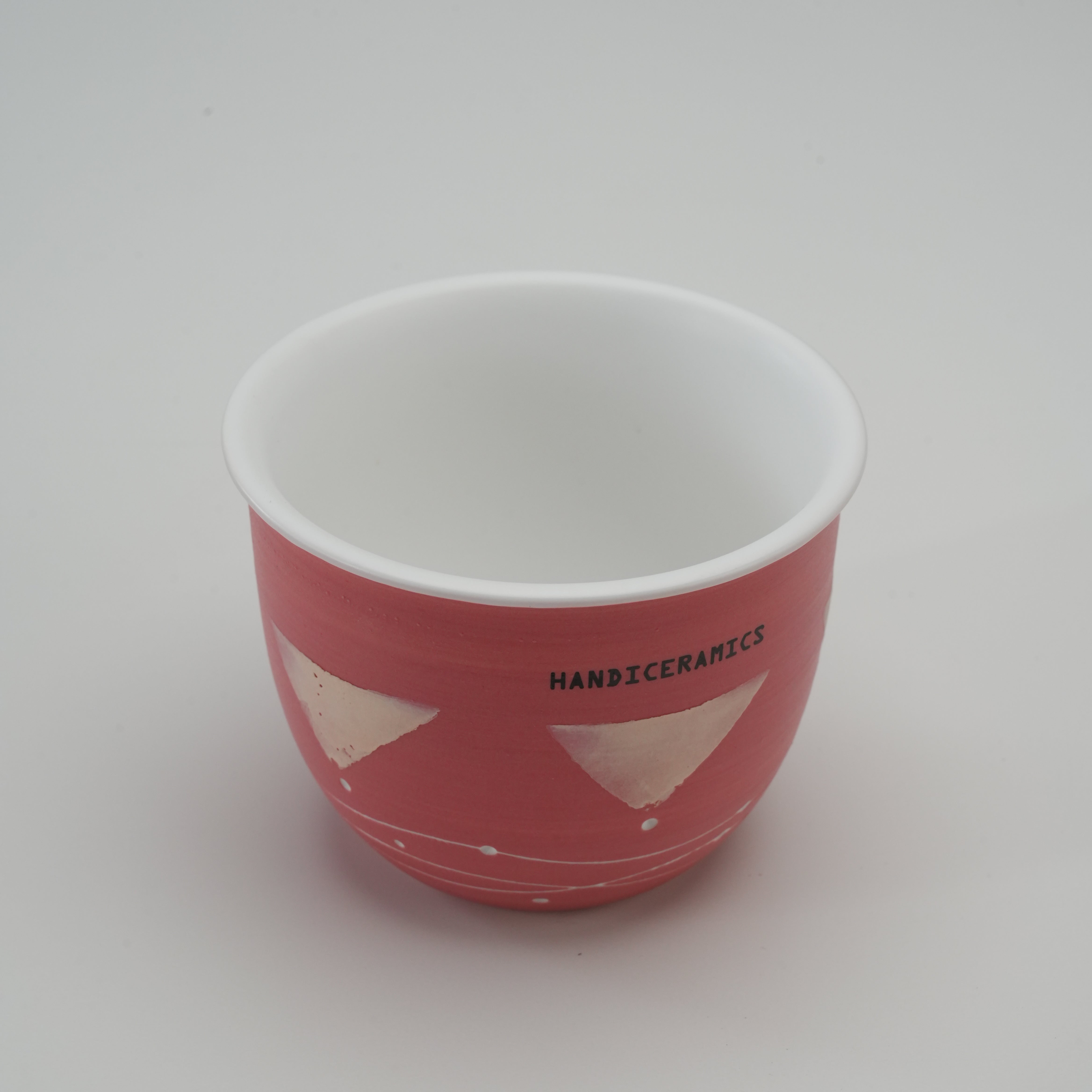 Top view of Handiceramics Travel Cup - Ceramic Coffee Cup without lid, revealing smooth white interior and artisan strawberry pink exterior for home or travel.