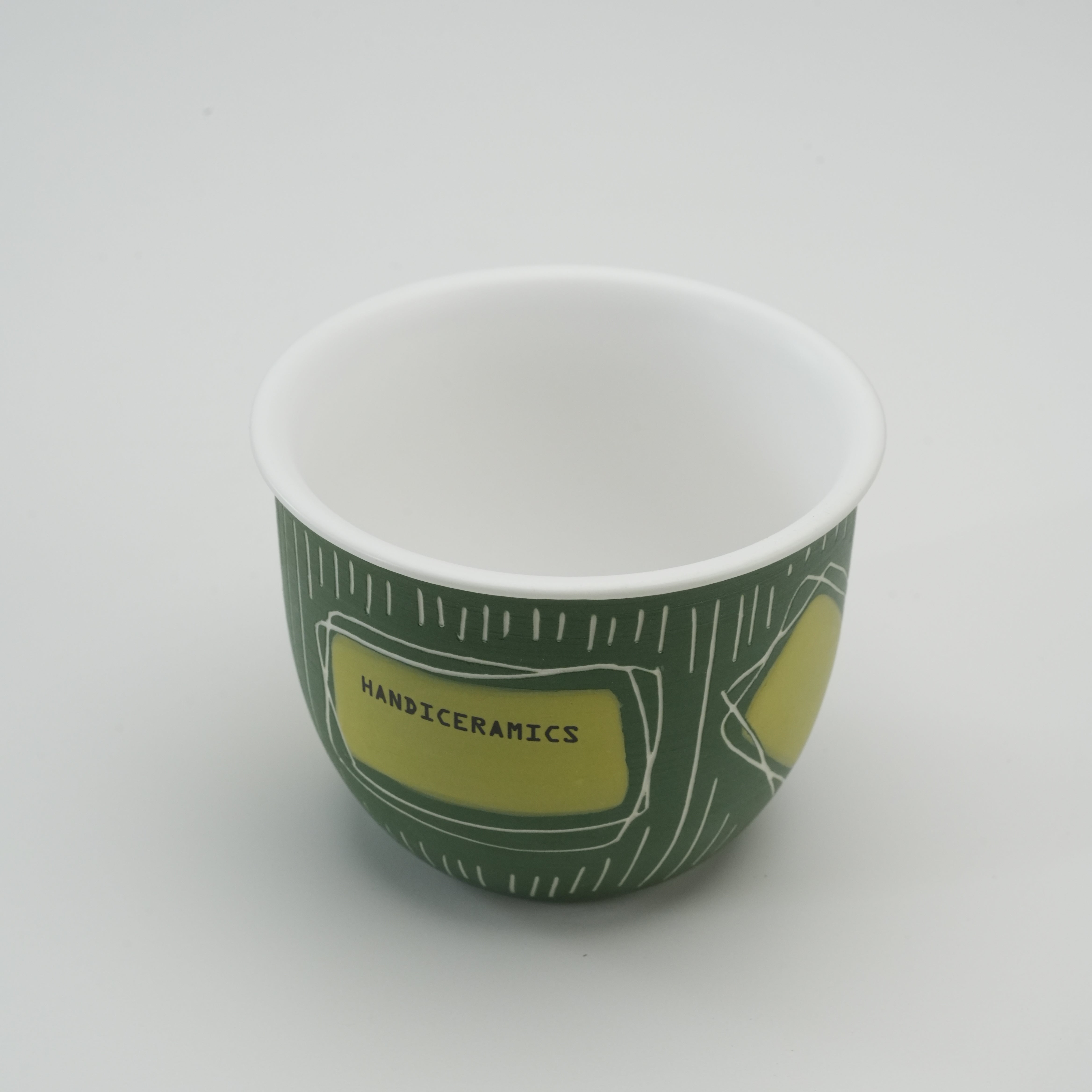 Interior view of Handiceramics Travel Cup - Ceramic Coffee Cup in Pandan, showing smooth white inner surface and artistic exterior design.