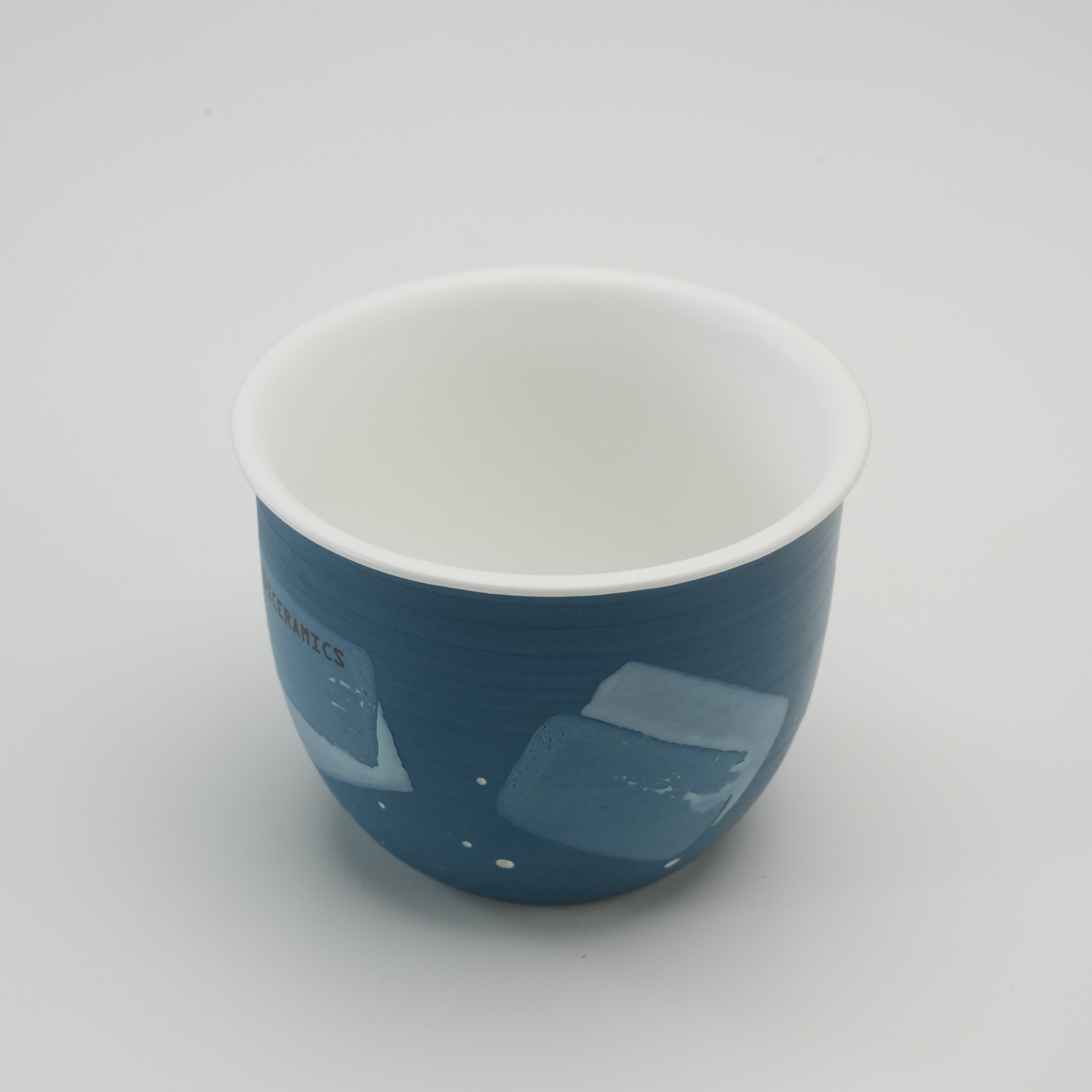 Interior view of Handiceramics Travel Cup - Blue Dream, showcasing white glazed ceramic inside and blue hand-painted exterior.