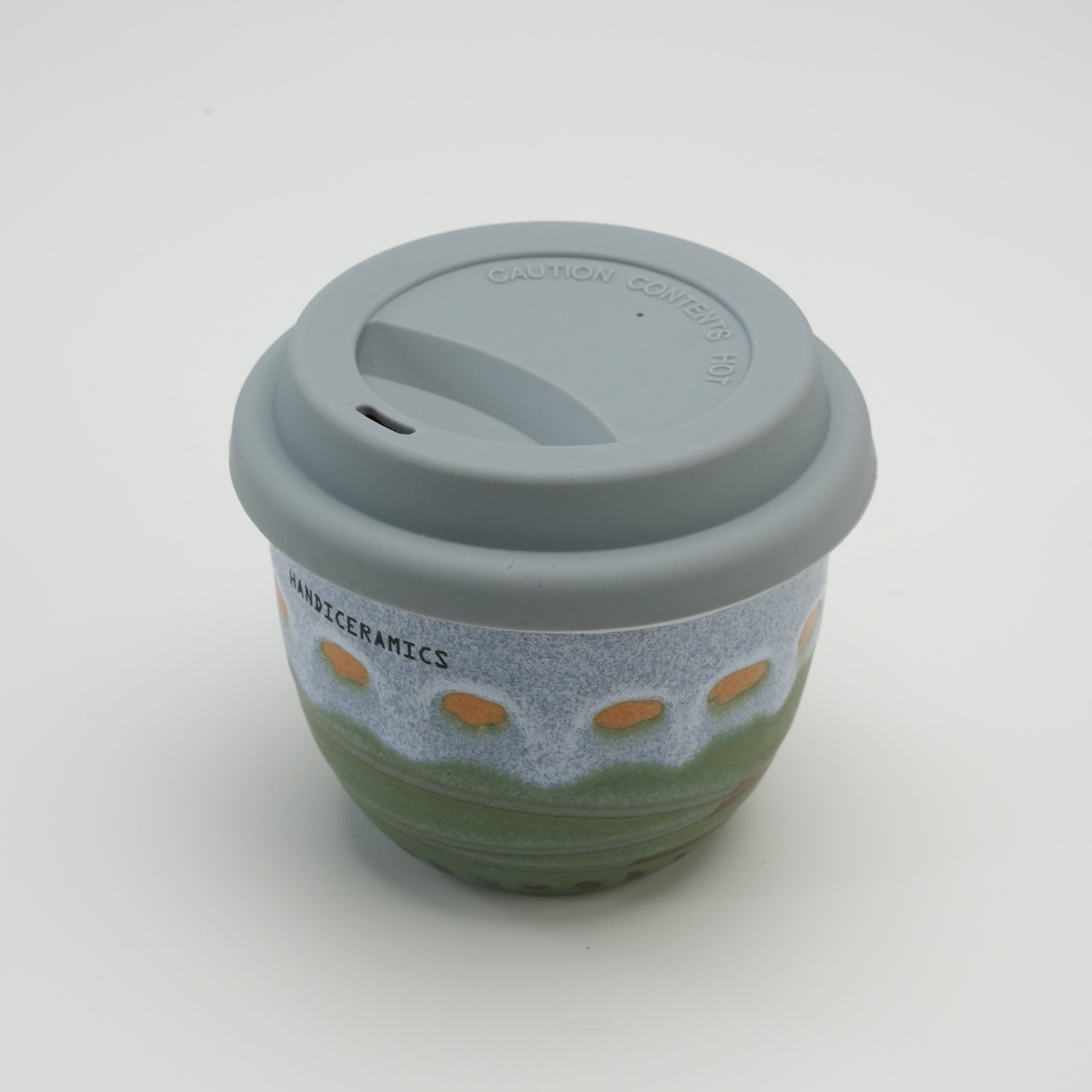 Palm Beach Handiceramics Travel Cup with silicone lid, showcasing a handmade ceramic coffee cup ideal for hot beverages on the go.