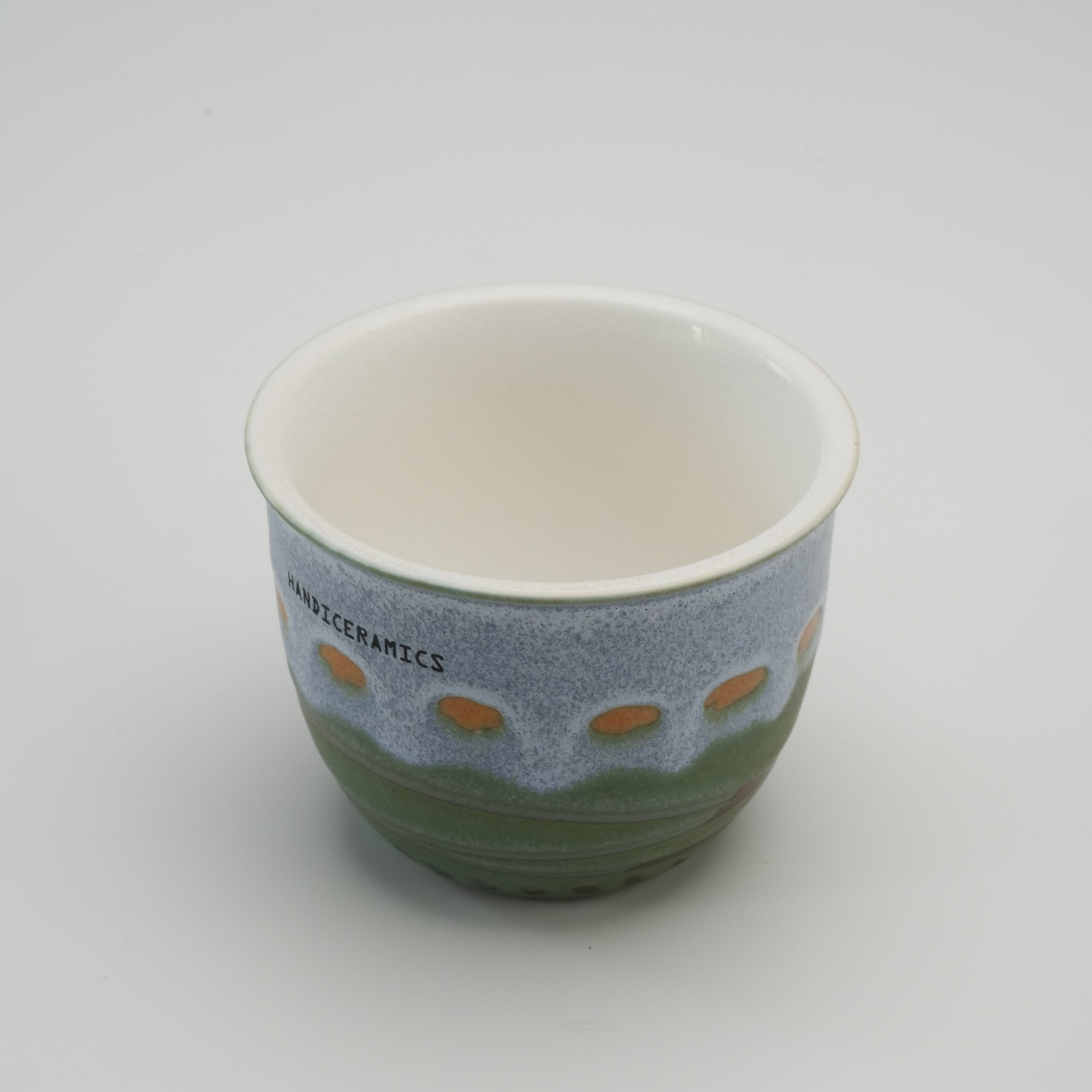 Interior view of the Handiceramics Acorn Travel Cup in Palm Beach, highlighting the smooth ceramic finish and artisanal craftsmanship.