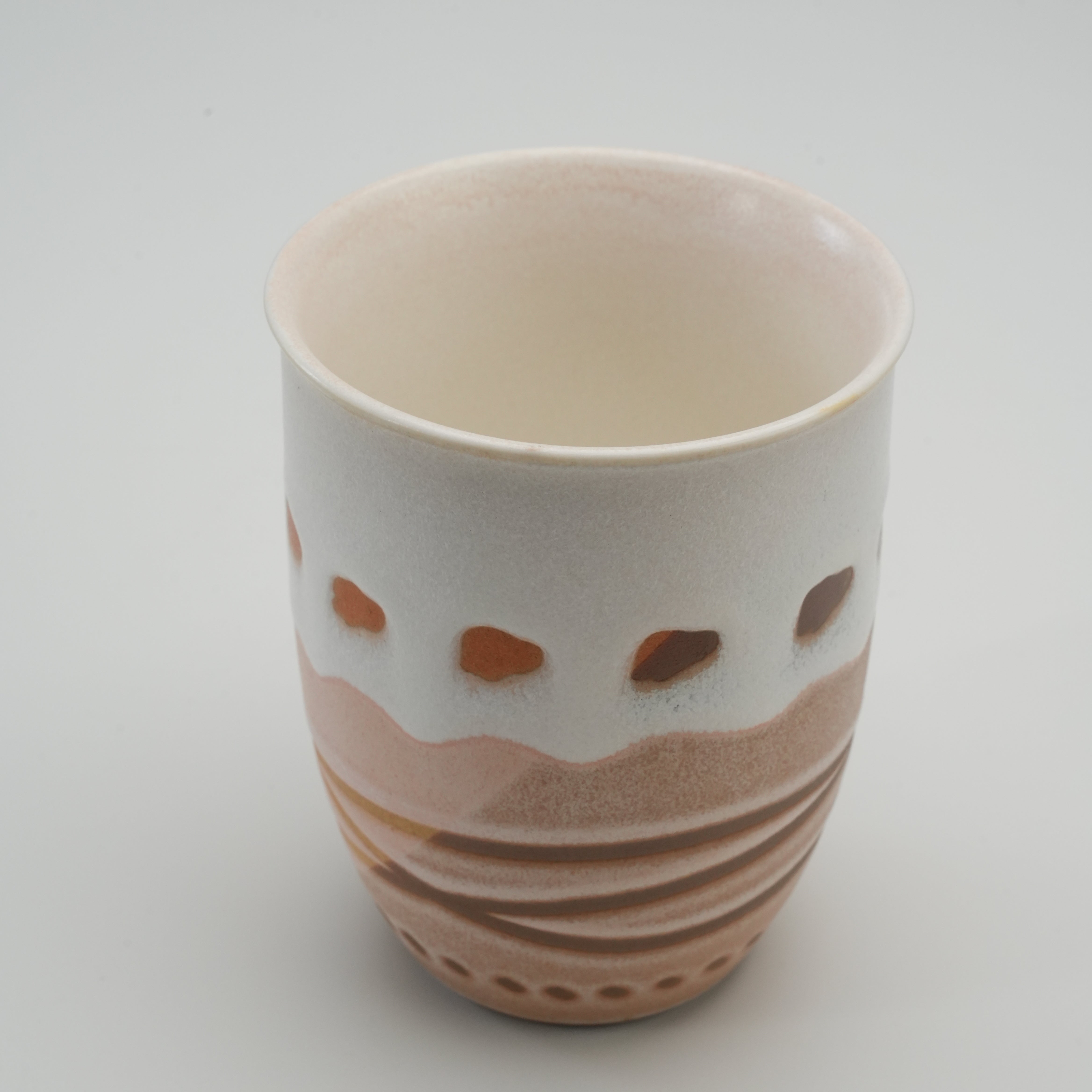 Large Handiceramics Acorn Travel Cup - Taro without lid, revealing a smooth cream interior and artisan terracotta exterior with wave and dot motifs.