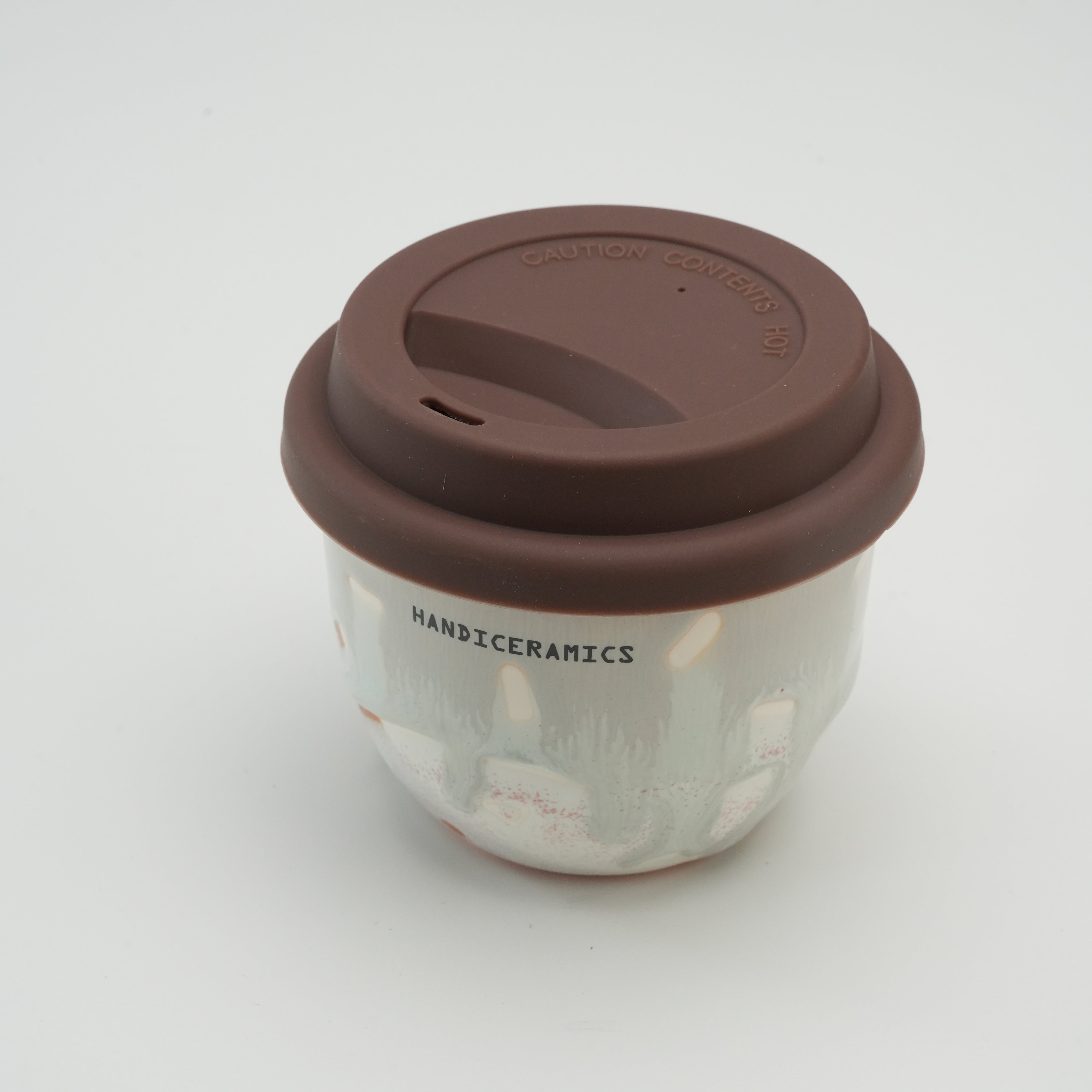 Handiceramics Boba Travel Cup in Orange Peel with eco-friendly ceramic body and brown silicone lid, ideal for coffee, tea, or boba on the go.