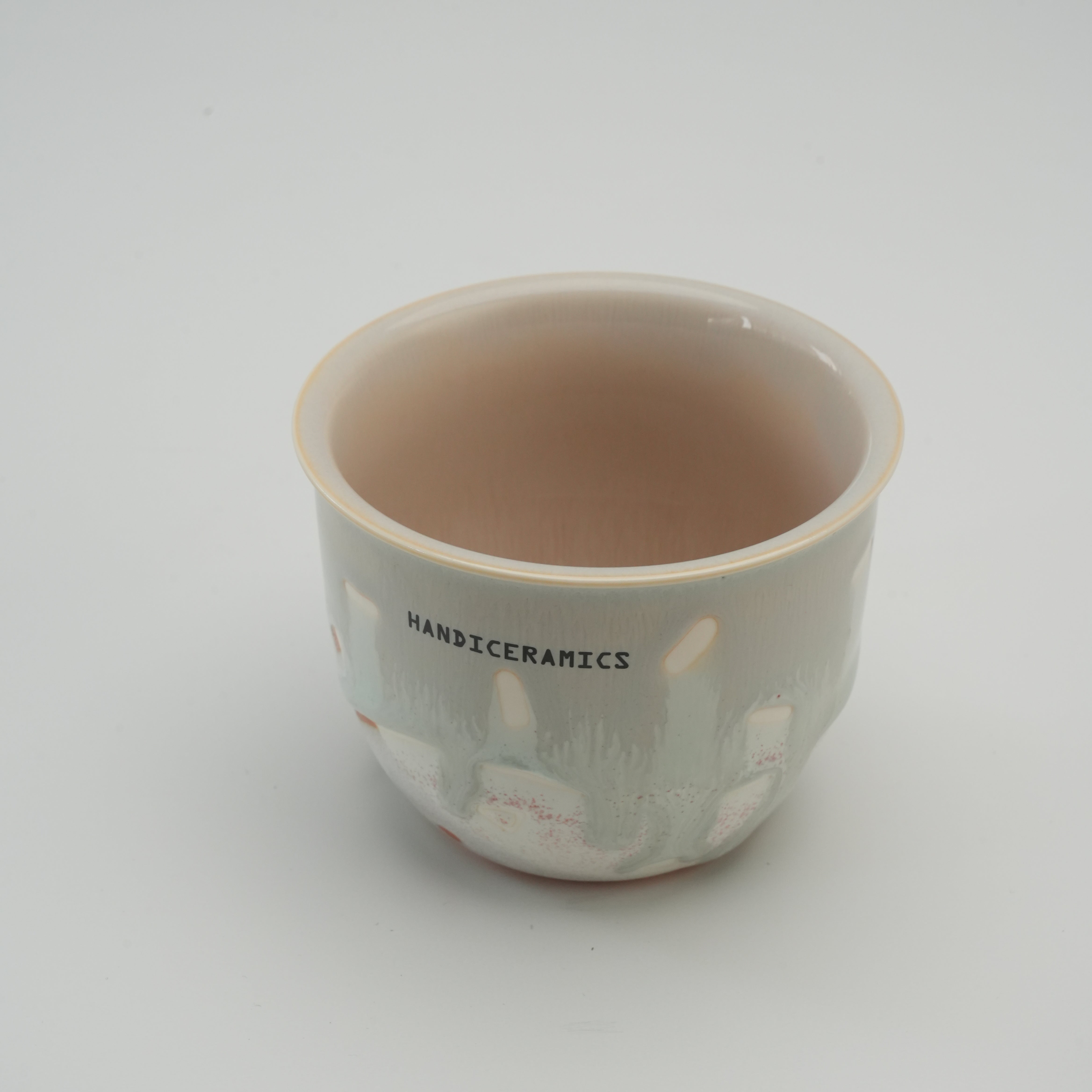Interior view of Handiceramics Travel Cup - Ceramic Coffee Cup in Orange Peel, showcasing smooth glazed finish and handmade craftsmanship.