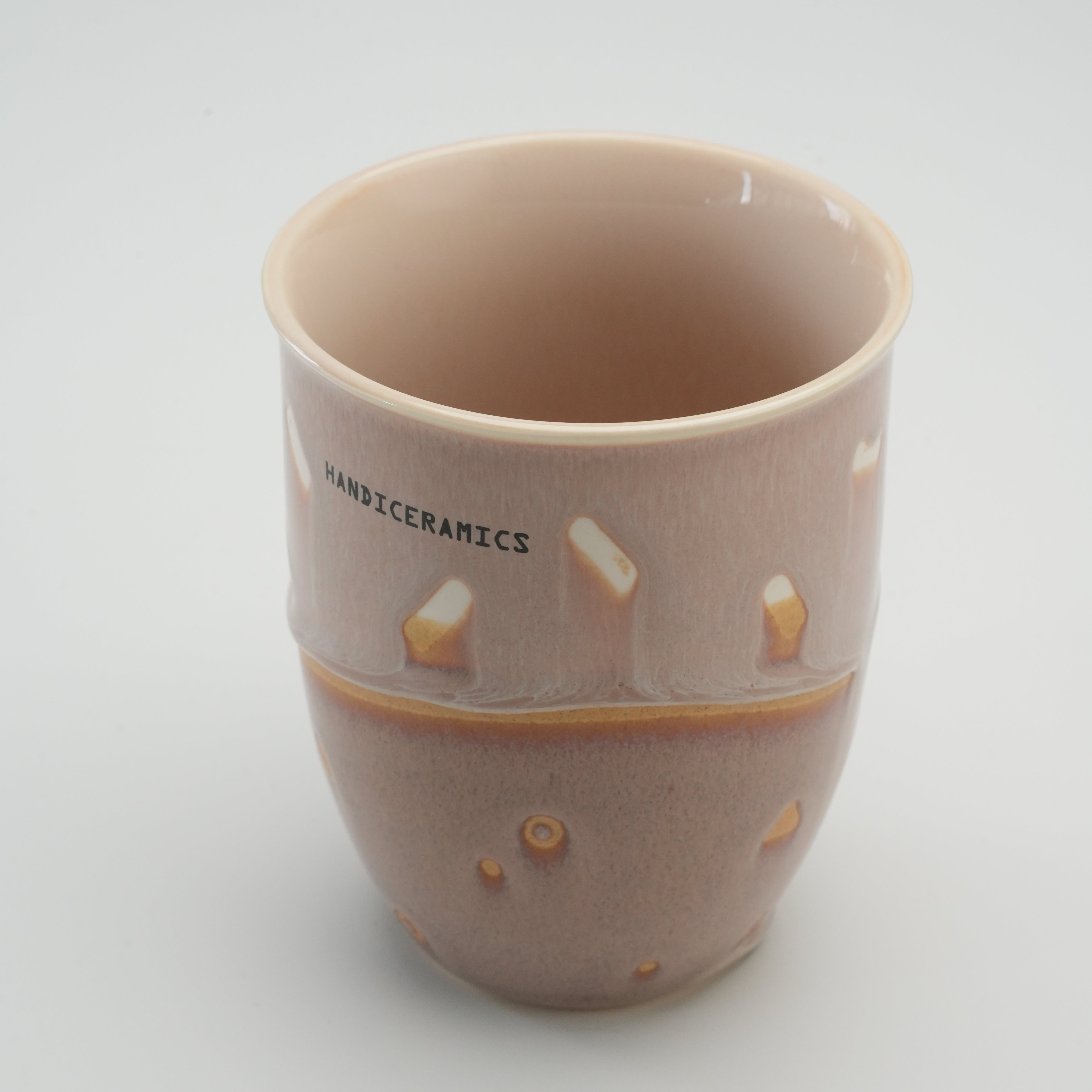 Interior view of the Taro Handiceramics Travel Cup, highlighting the handcrafted ceramic build and ergonomic shape for comfortable use.
