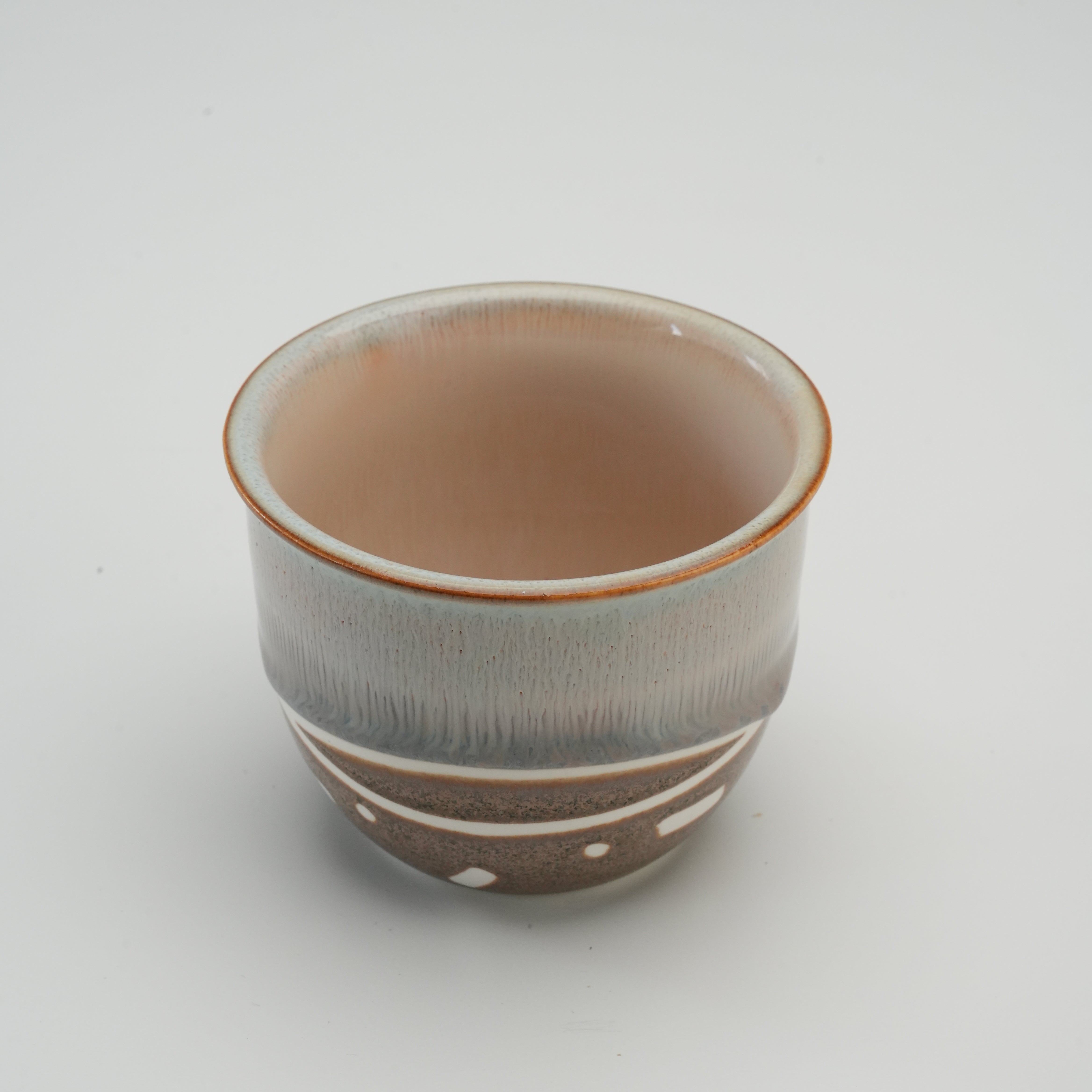 Open view of Handiceramics Travel Cup in Brown Sugar, showcasing smooth glazed interior and artisan-crafted ceramic body.