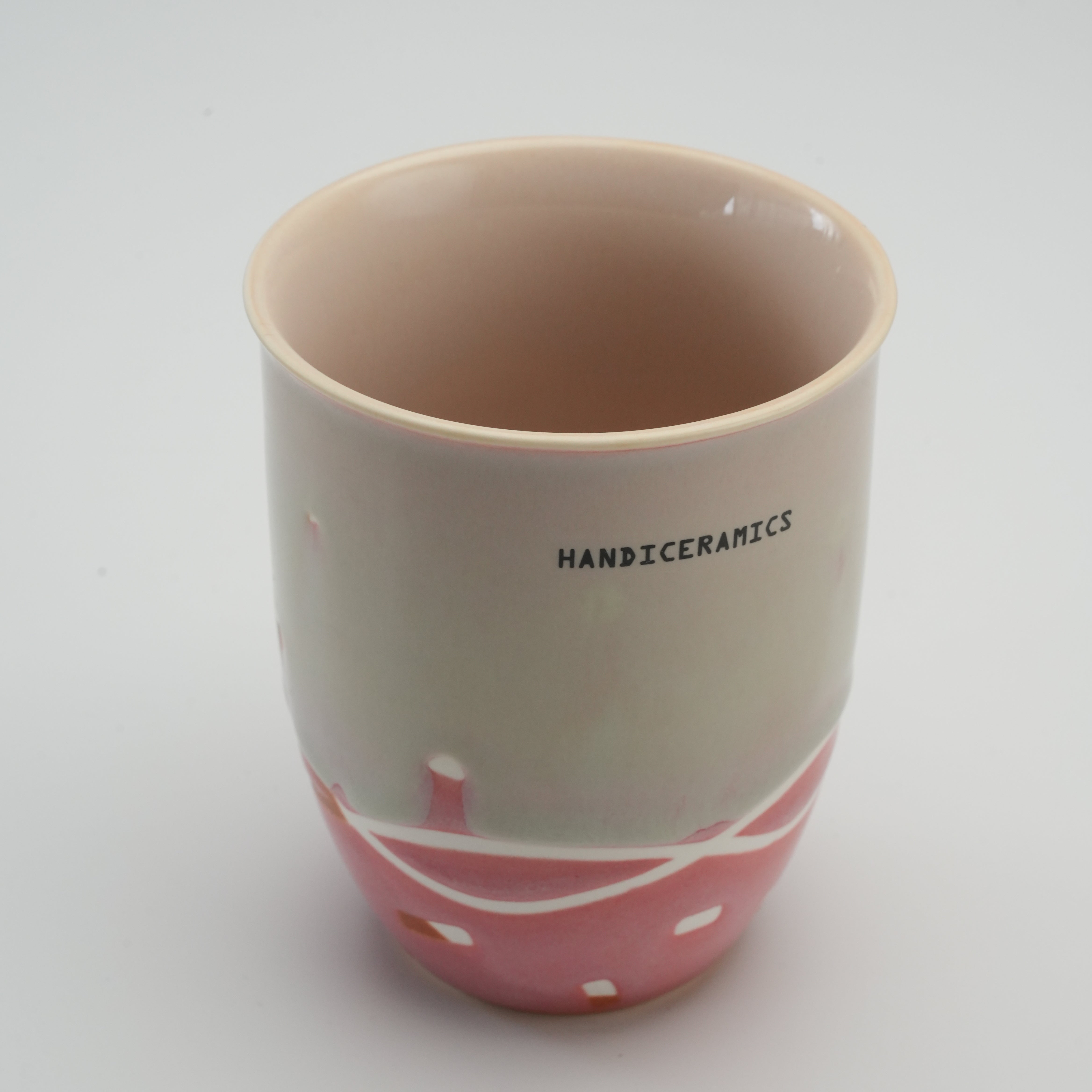 Interior view of tall Handiceramics Travel Cup in strawberry pink, highlighting its spacious ceramic build and artisan craftsmanship.