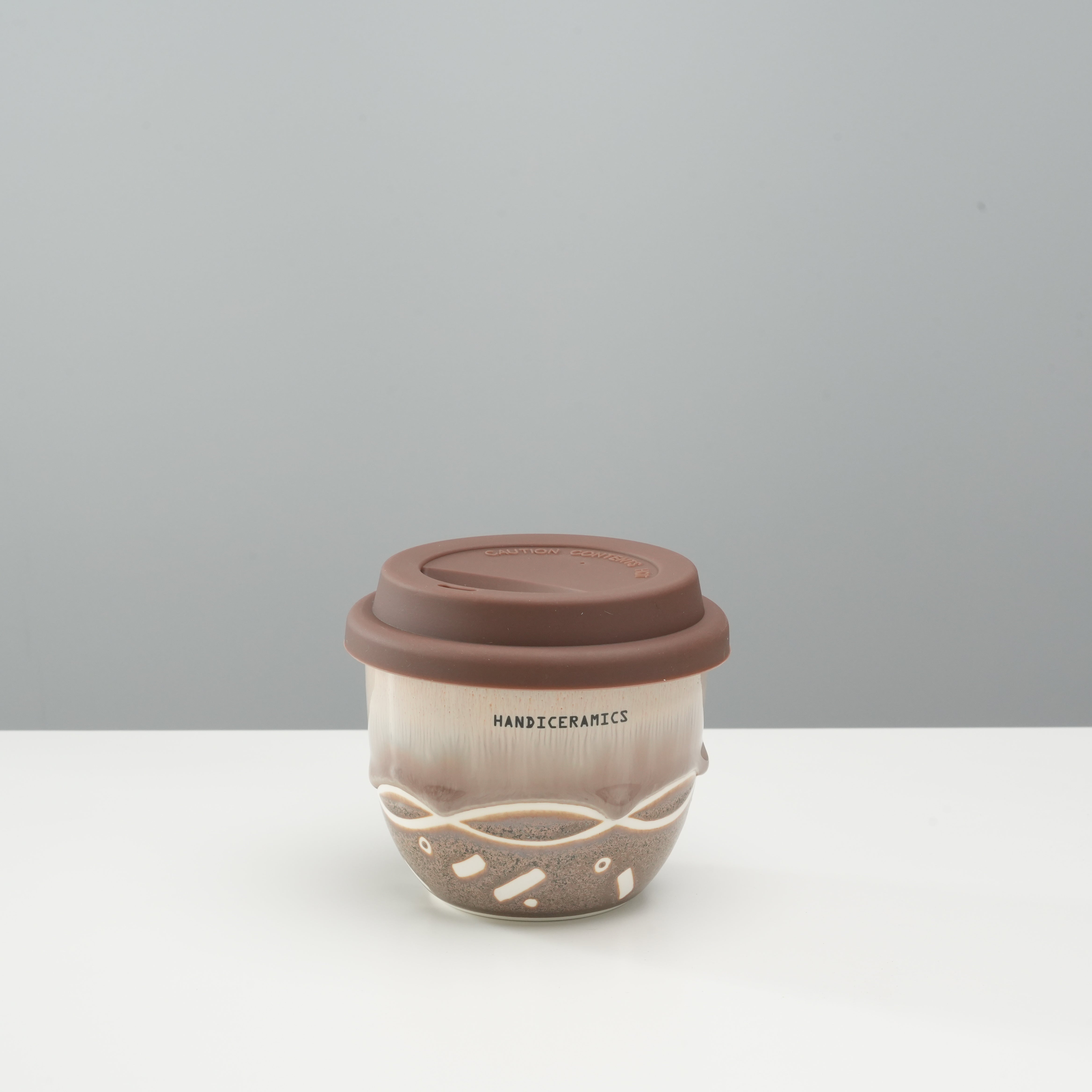 Handiceramics Travel Cup - Ceramic Coffee Cup with Lid in Brown Sugar color, featuring handmade porcelain with silicone lid for on-the-go use.