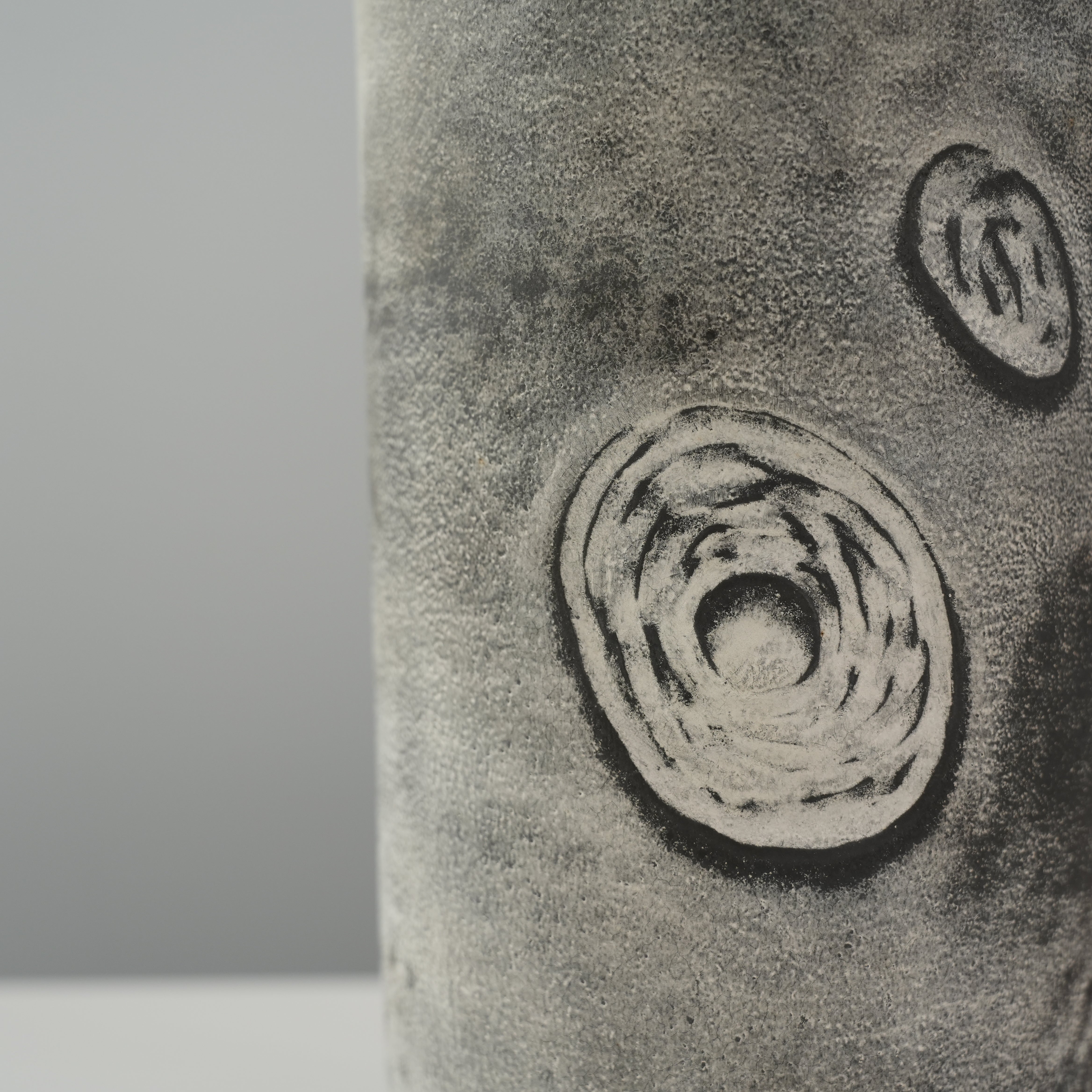 Zoomed-in view of Starry Night Cylinder Vase showcasing celestial swirl motifs and fine surface texture in silver glaze finish.