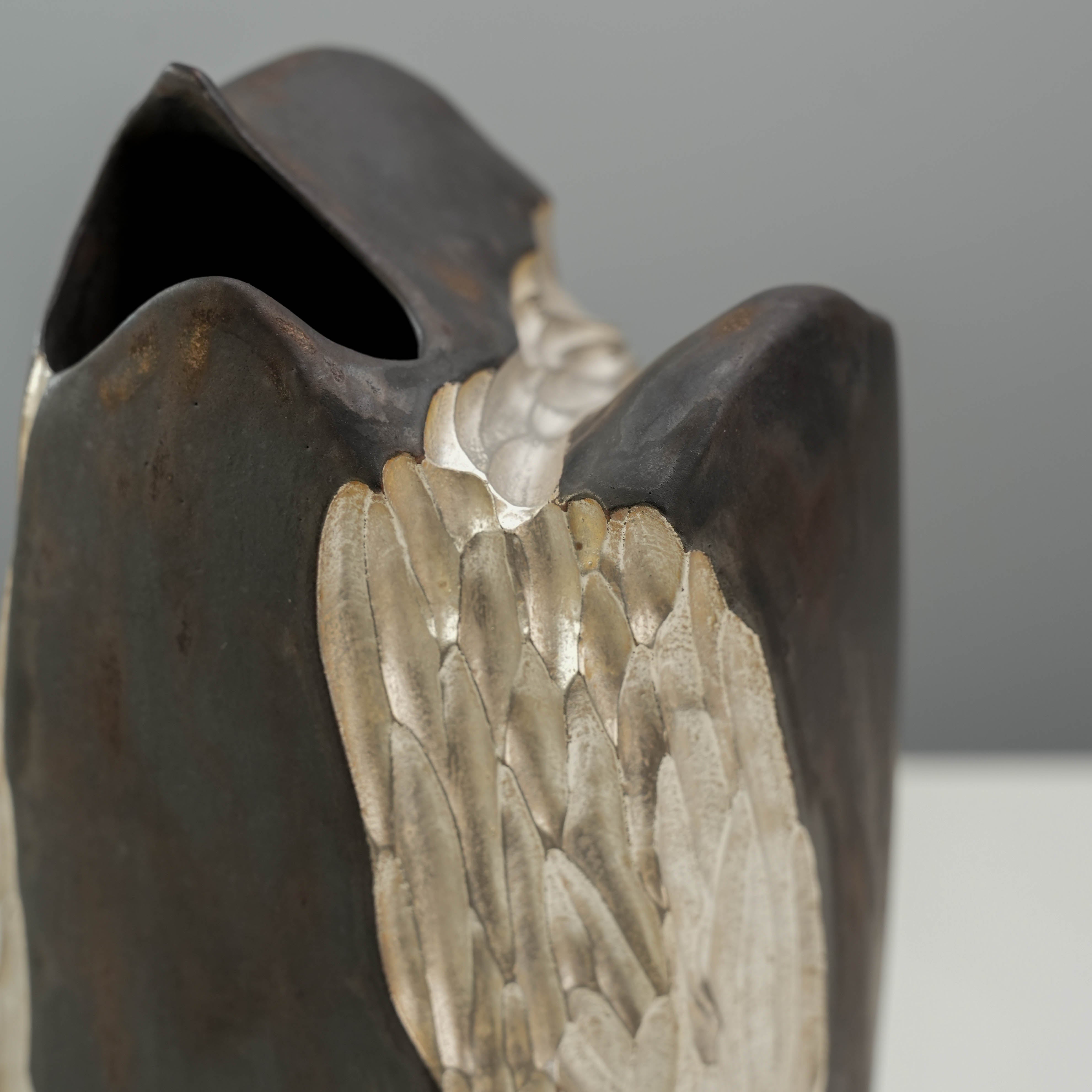 Angled close-up of the Lonesome Studio Vase showing silver mountain textures blending into the dark ceramic body.