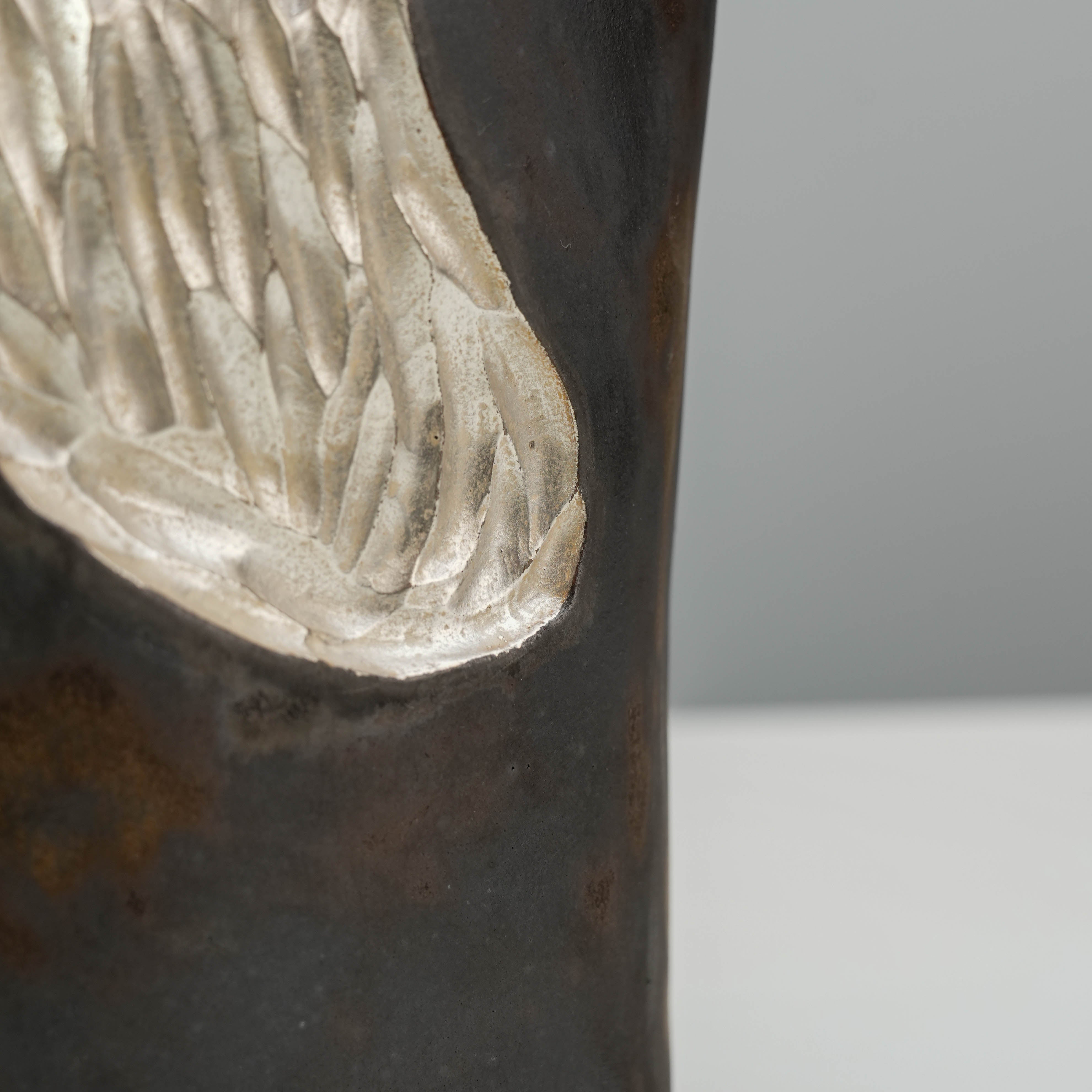 Lower section detail of the Mountain Form Vase, emphasizing the silver carved texture against the black-gold ceramic.