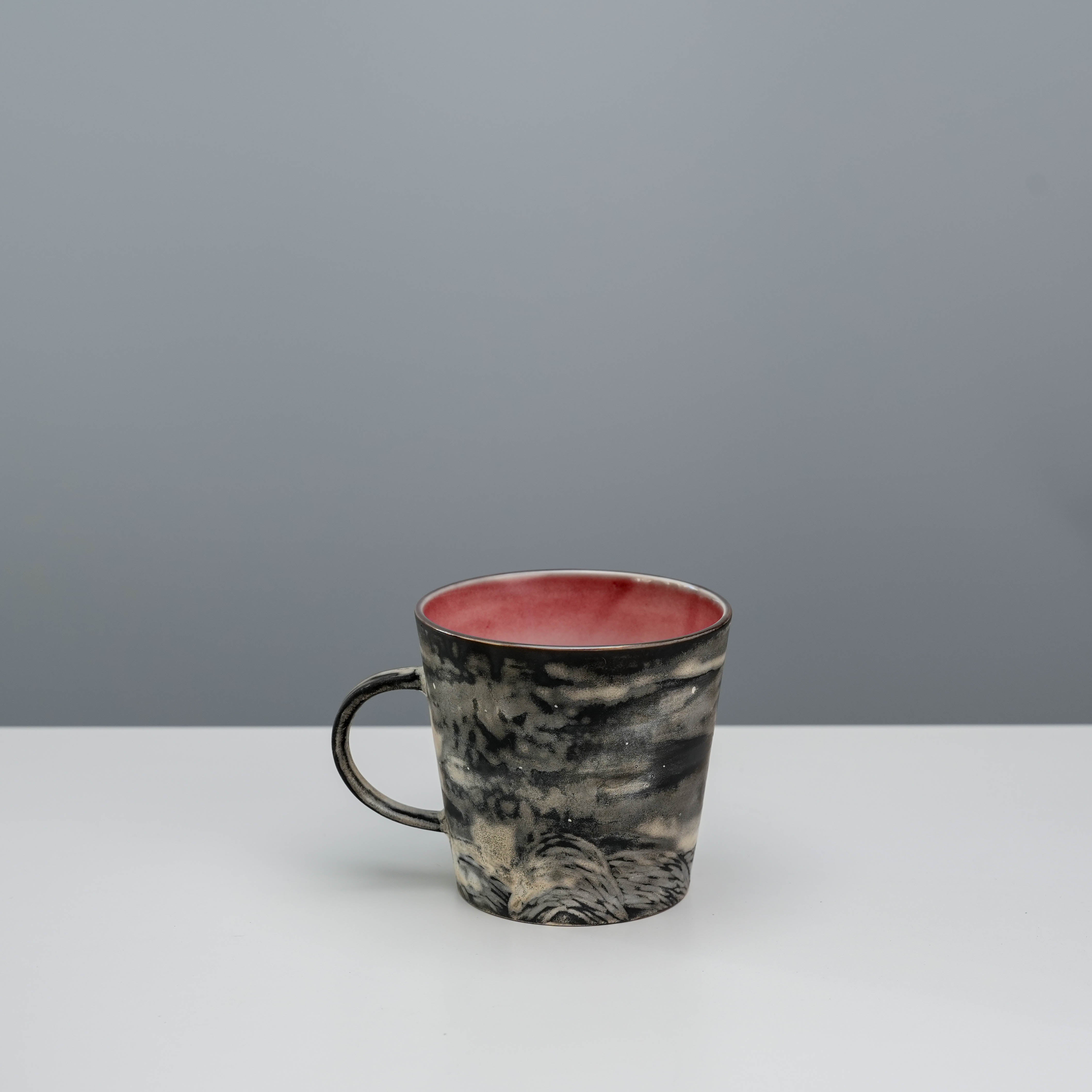 Back view of Lonesome Studio Crescent Moon Mug showing hand-painted silver glaze patterns and textured landscape detail.