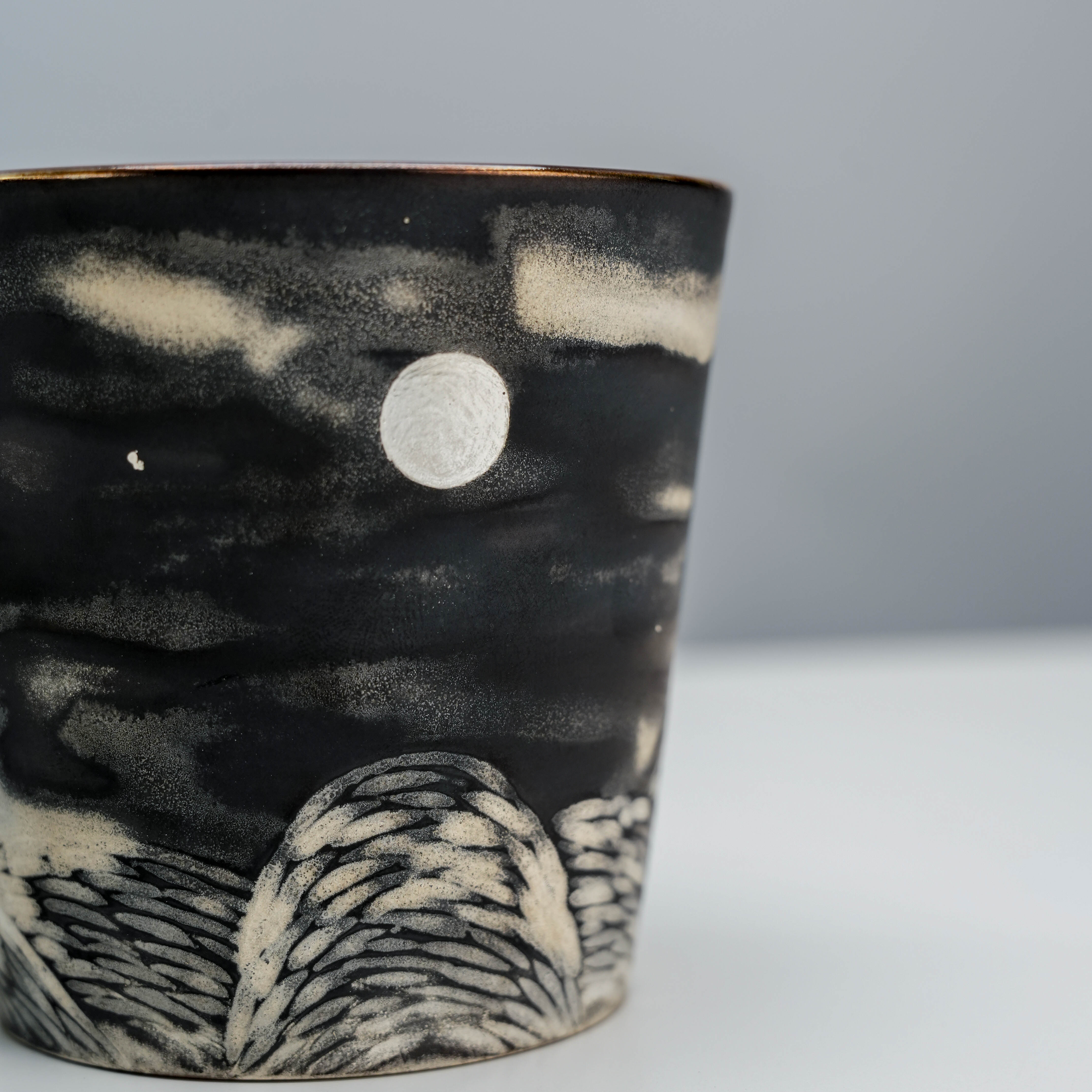 Close-up of Lonesome Studio Full Moon Mug showing detailed silver-glazed moon and carved landscape, perfect for unique mug enthusiasts.