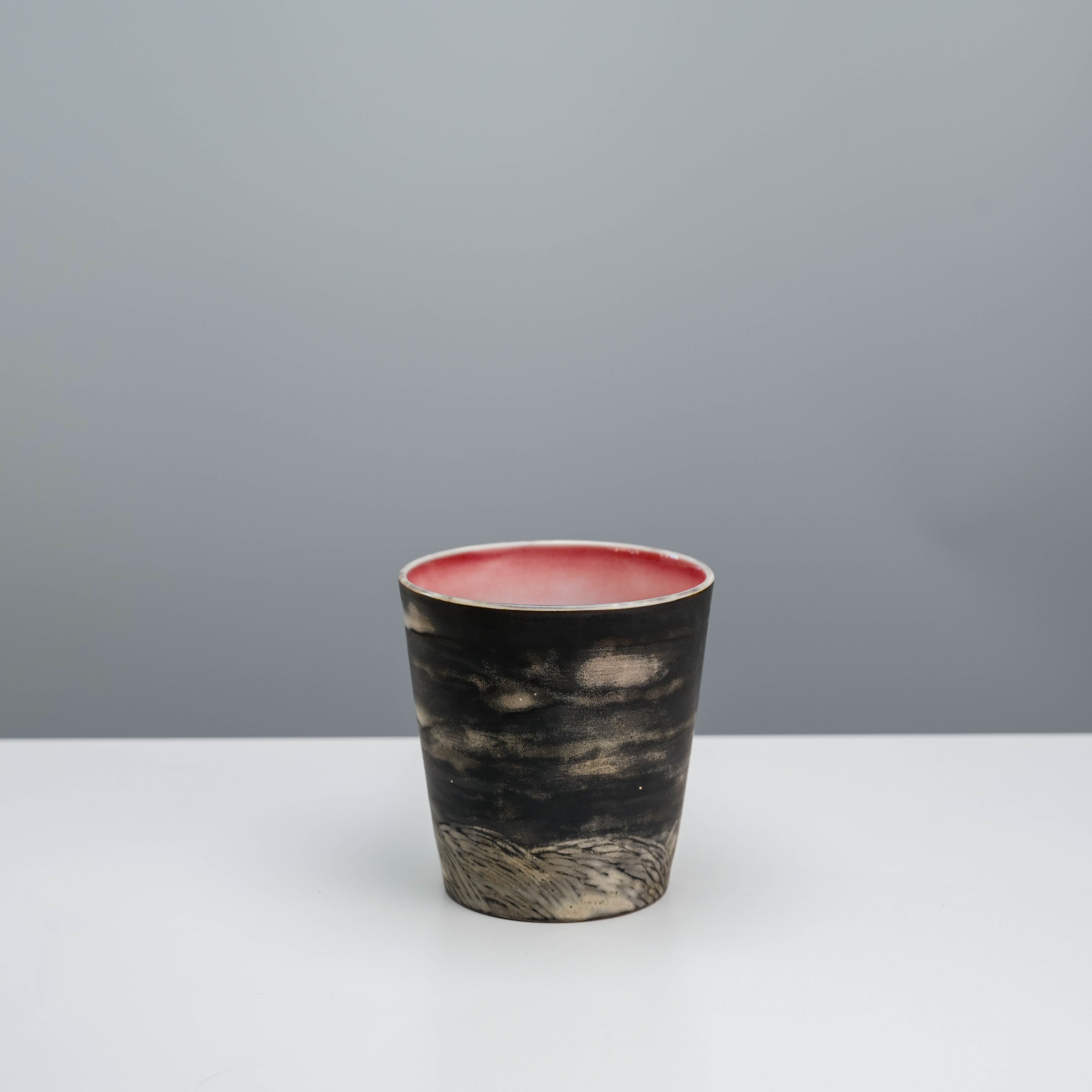 Alternate angle of Lonesome Studio Moon Tumbler highlighting engraved mountain scenery and matte black glaze.