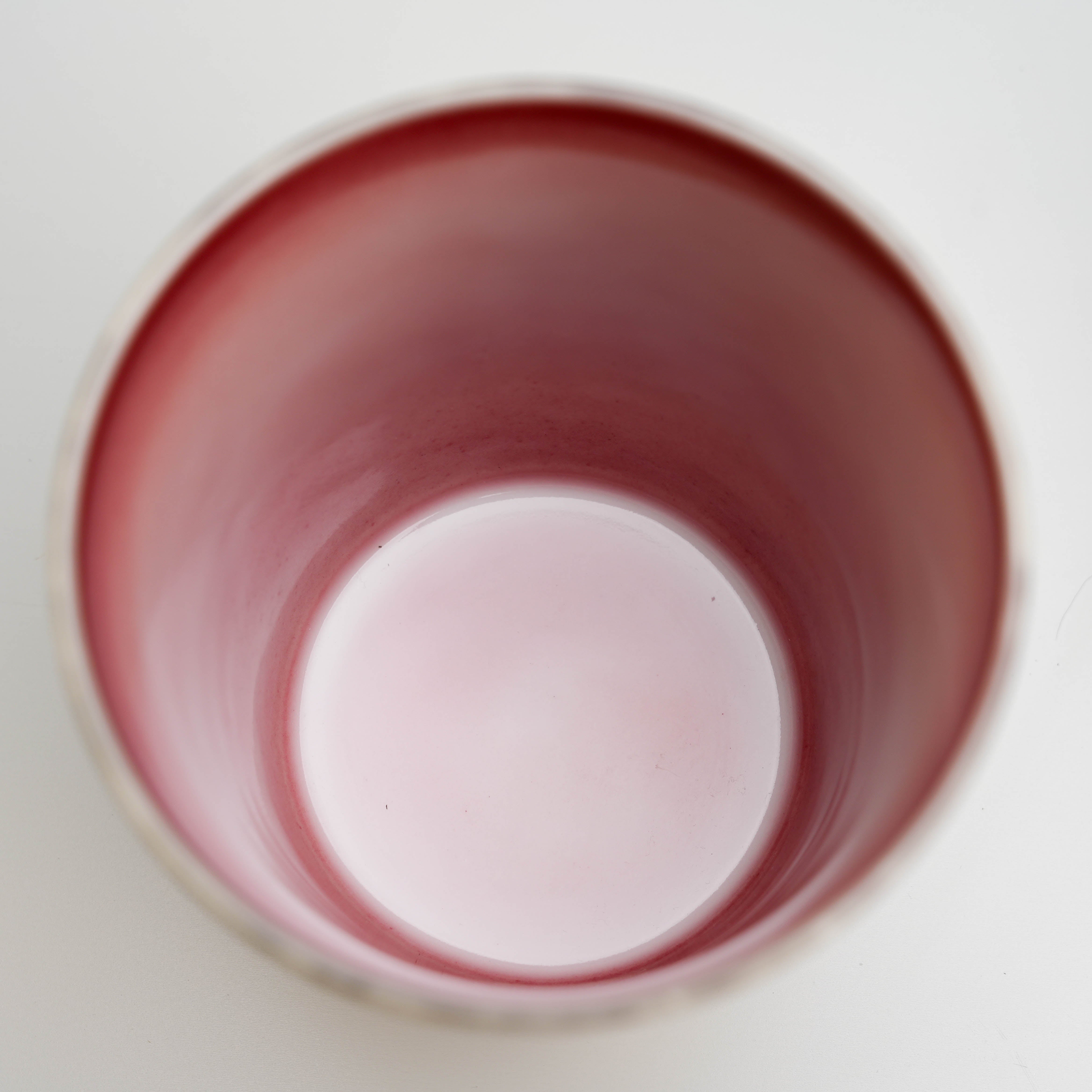 Top view of Lonesome Studio Moon Tumbler showing smooth red-pink glazed interior, perfect for hot beverages.