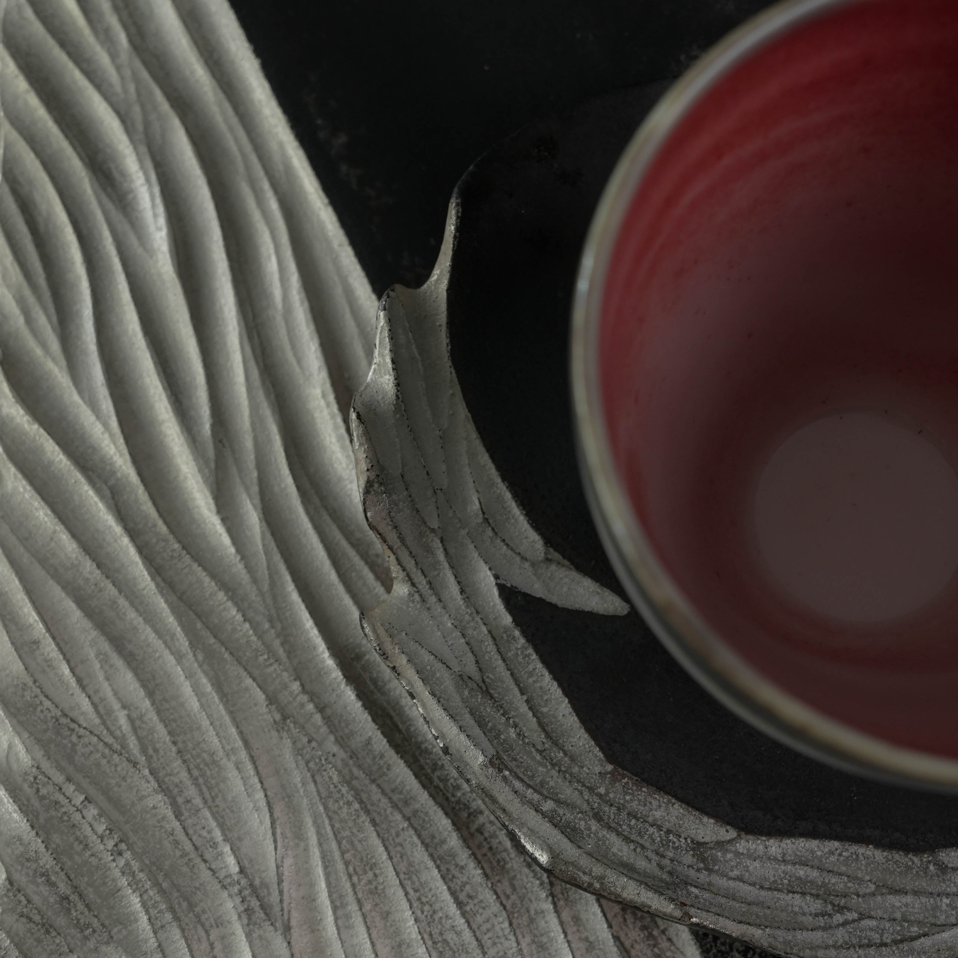 Close-up of Lonesome Studio Gushan Tea Set saucer with silver glaze texture, showcasing handmade craftsmanship and elegant design.
