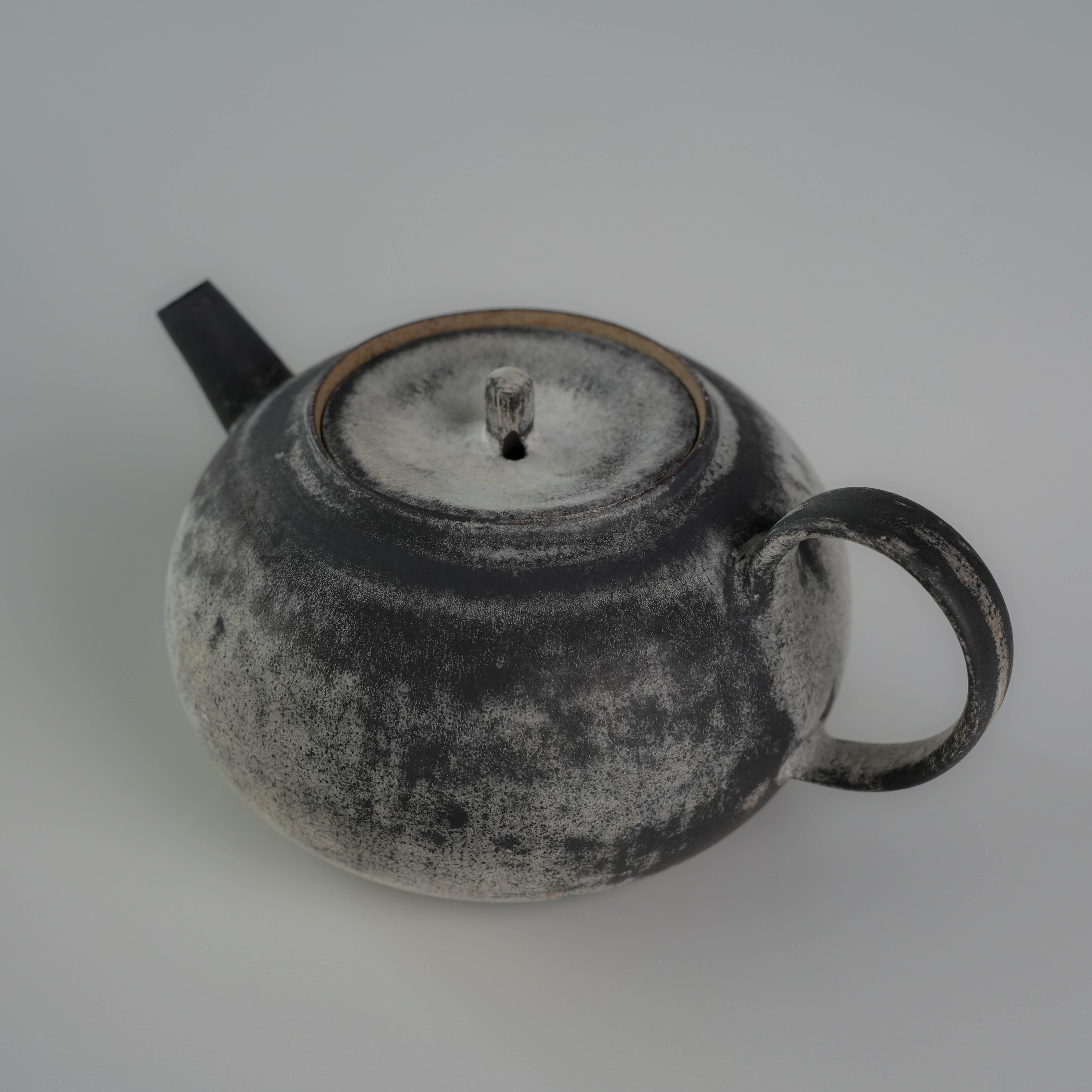 Top angle of Lonesome Studio Gushan Tea Set teapot showing the lid and handle, finished in handmade silver glaze.