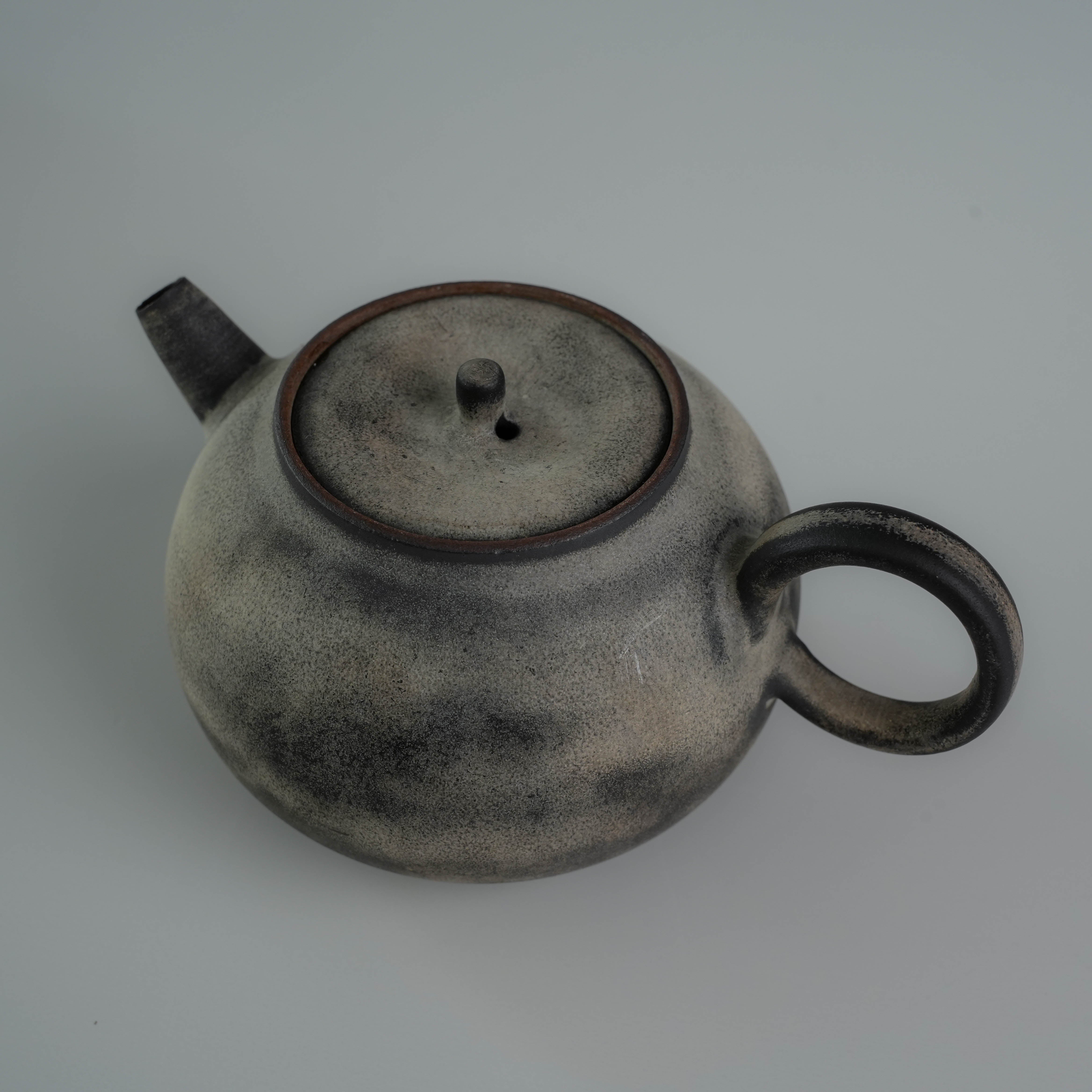 Top view of Lonesome Studio Gushan Tea Set teapot lid and spout, showcasing the handmade ceramic texture.