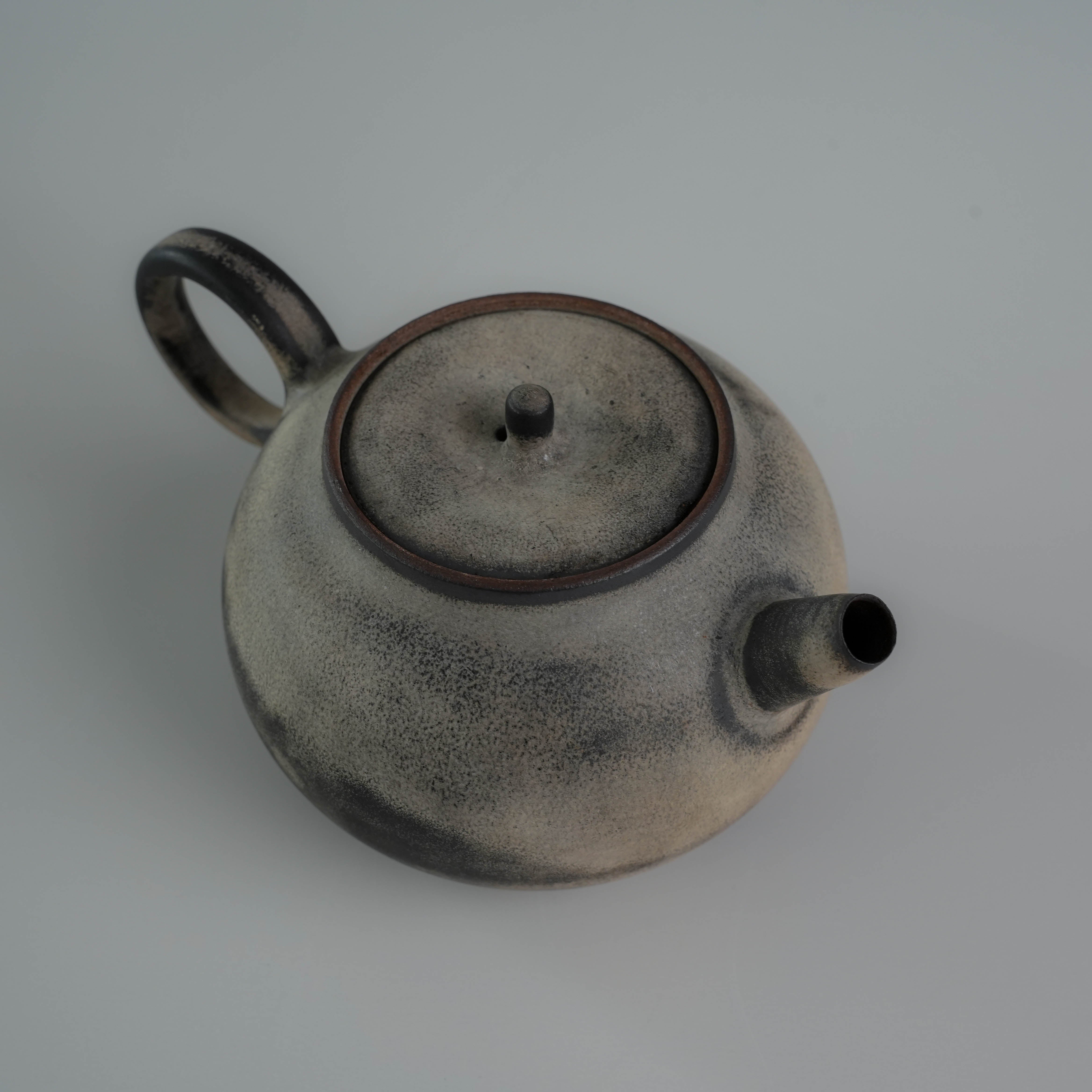 Angled top view of Lonesome Studio Gushan Tea Set teapot with visible spout and lid, featuring elegant glaze finish.