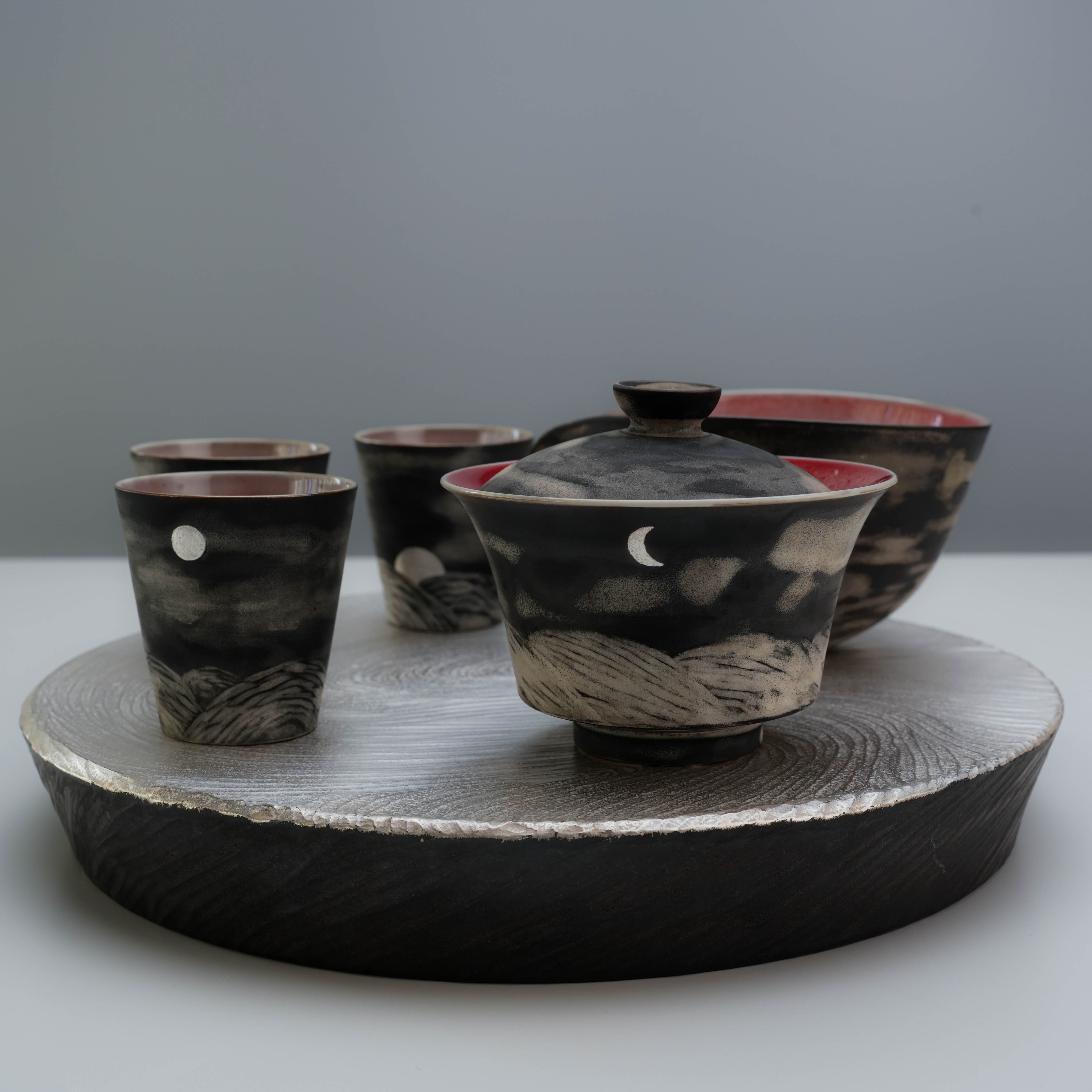 Handmade Lonesome Studio Qushui Tea Set with silver glaze, showcasing moon phase cups and a gaiwan on a textured silver tray for Gongfu Cha.