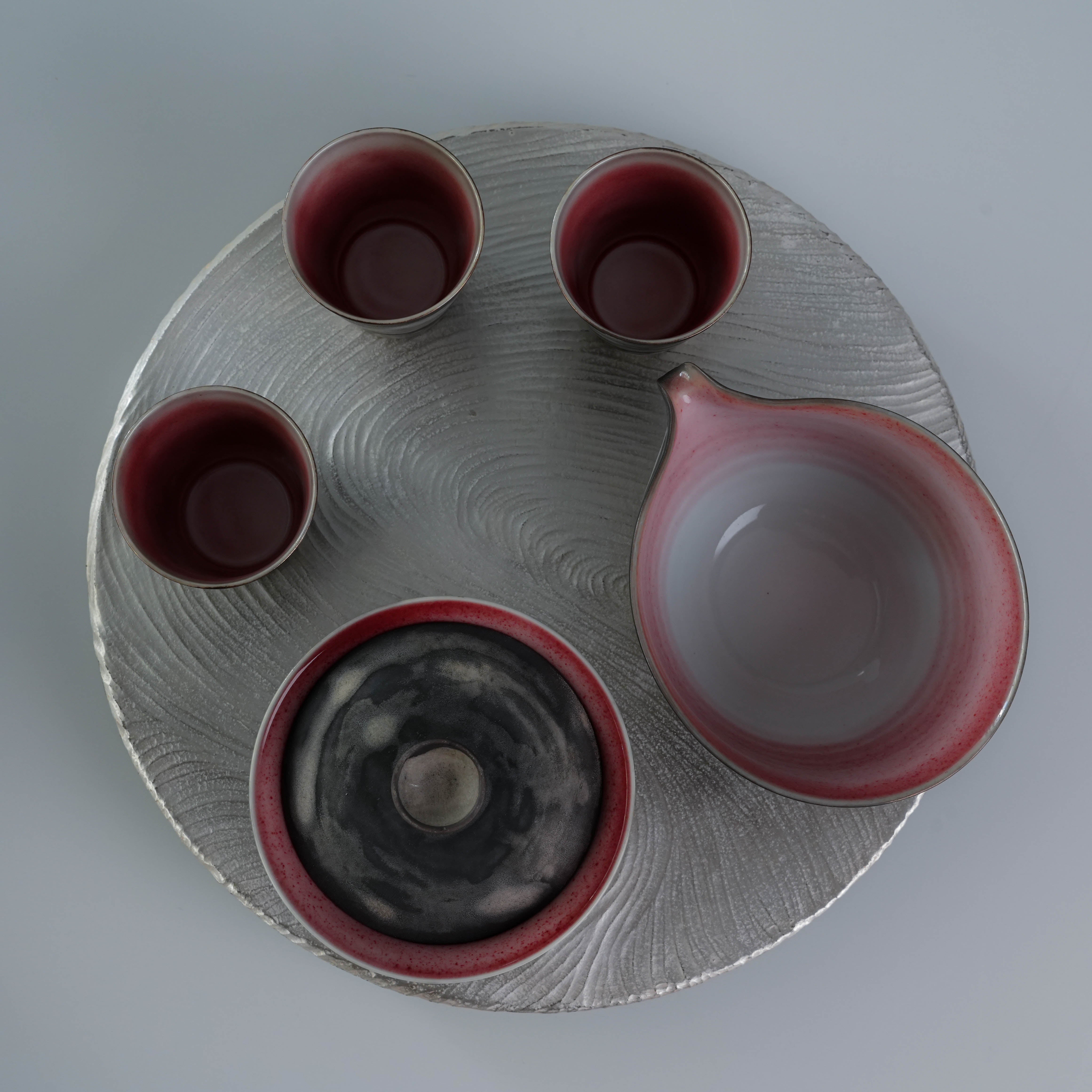 Top view of Lonesome Studio Qushui - Silver Glaze Tea Set, highlighting red-glazed interiors and elegant handmade Gongfu Cha arrangement.