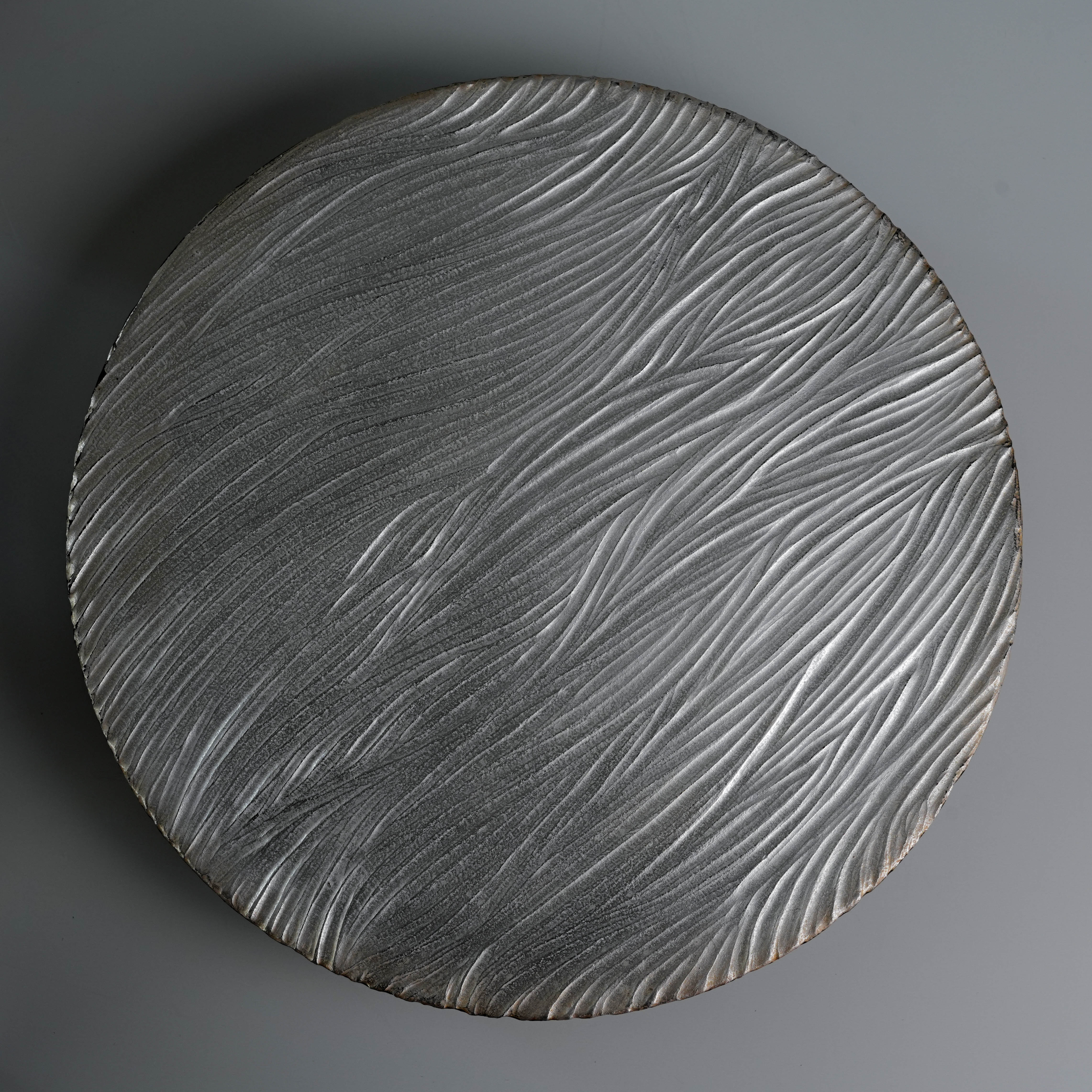 Textured silver tray from Lonesome Studio Qushui Tea Set, handmade with swirling patterns to complement the Gongfu Cha tea experience.
