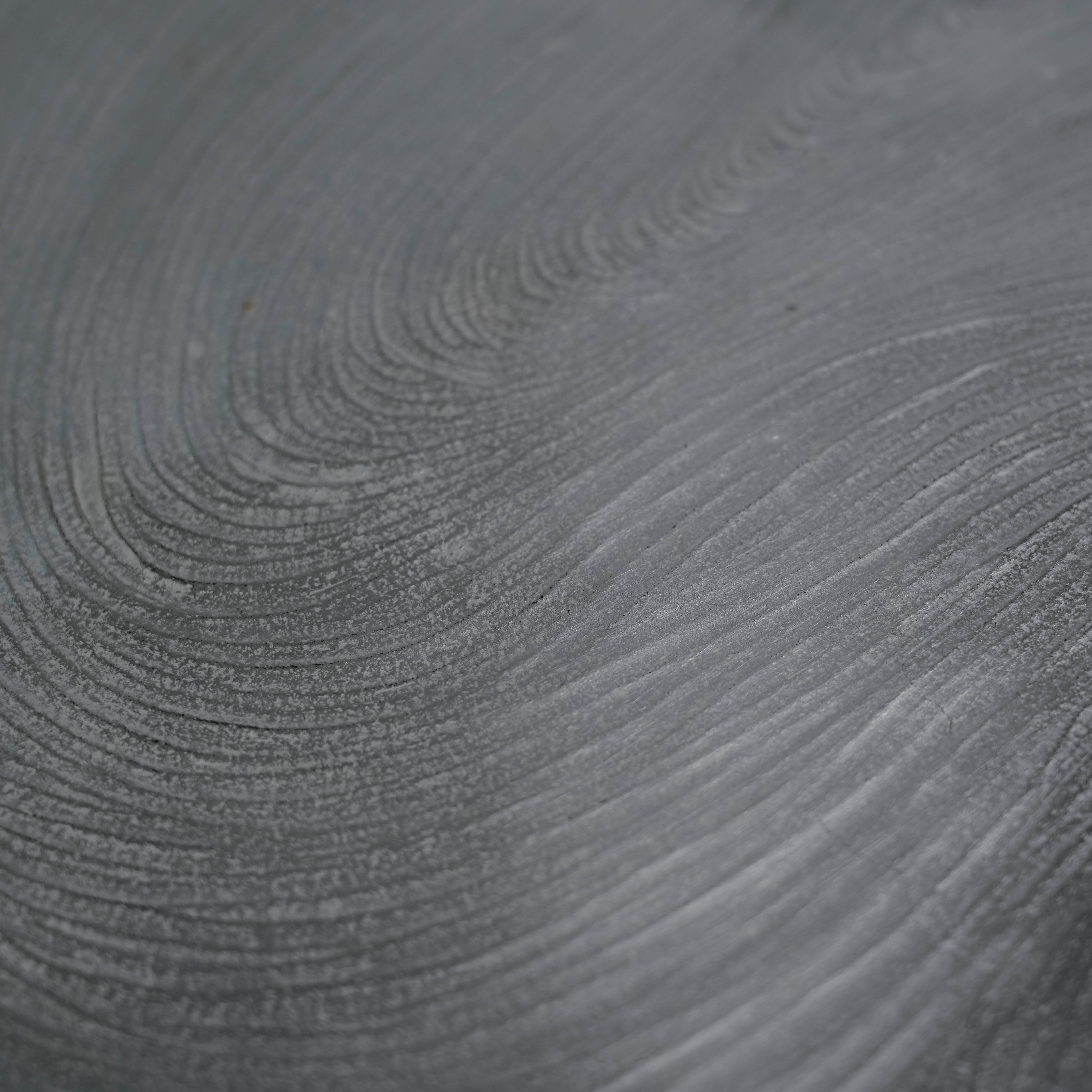 Close-up of swirling silver texture on Lonesome Studio Qushui tea tray, highlighting handmade craftsmanship for Gongfu Cha tea set.