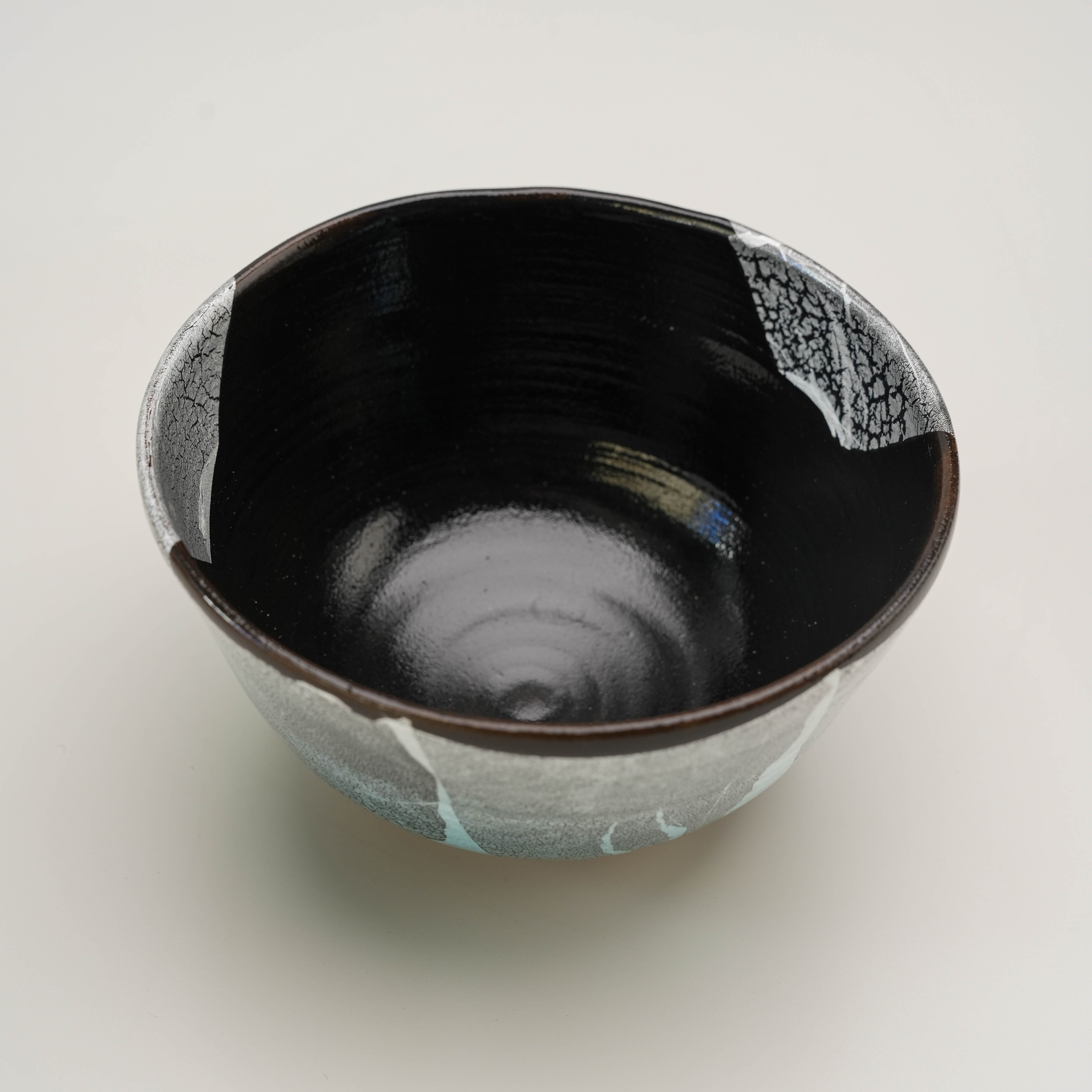 Interior view of Kutani Ware Silver Leaf Bowl with glossy black glaze, crafted for tea ceremonies or artistic dinnerware.