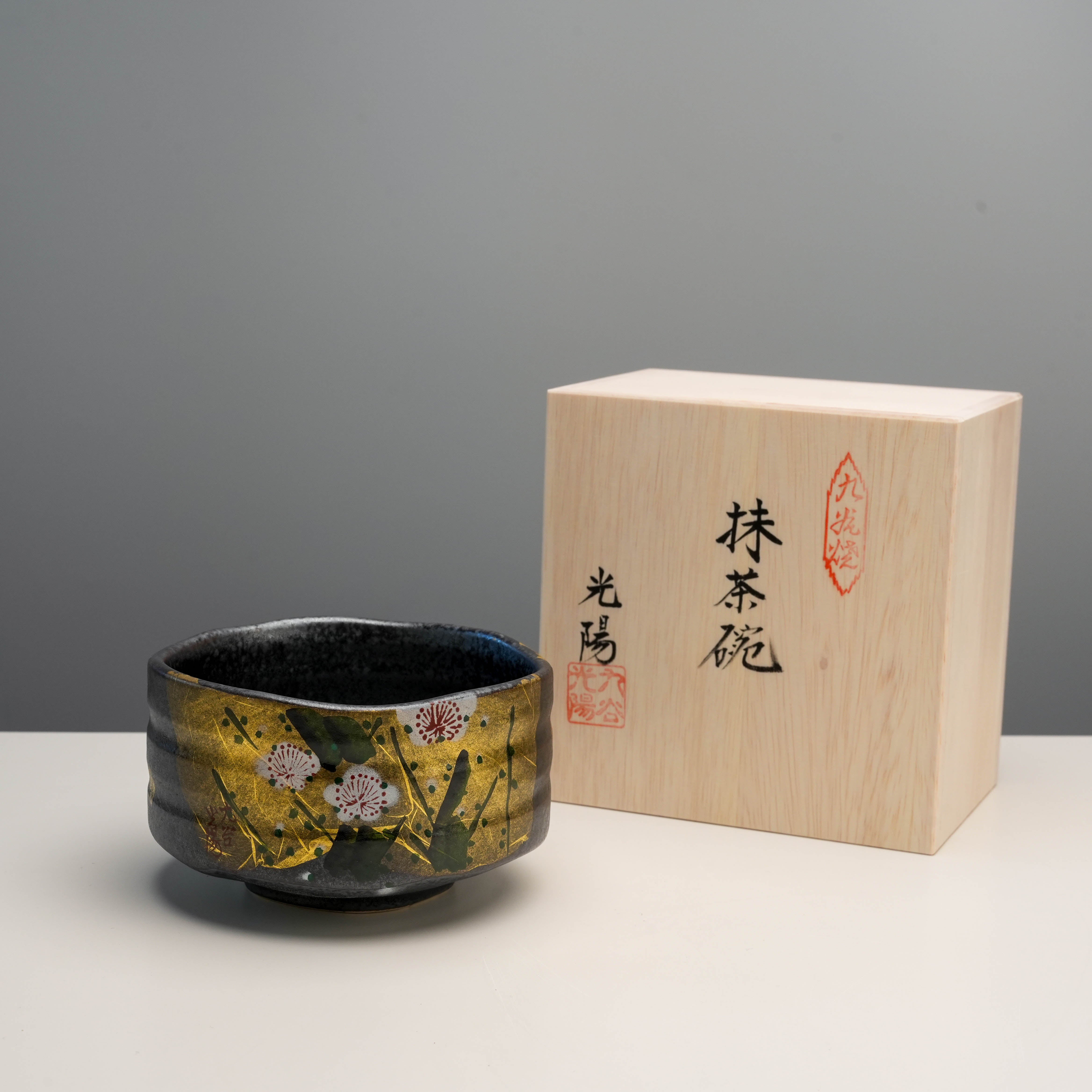 Kutani Ware Gold Leaf Plum Blossom Matcha Bowl with wooden box, showcasing Japanese craftsmanship and ideal for matcha preparation.