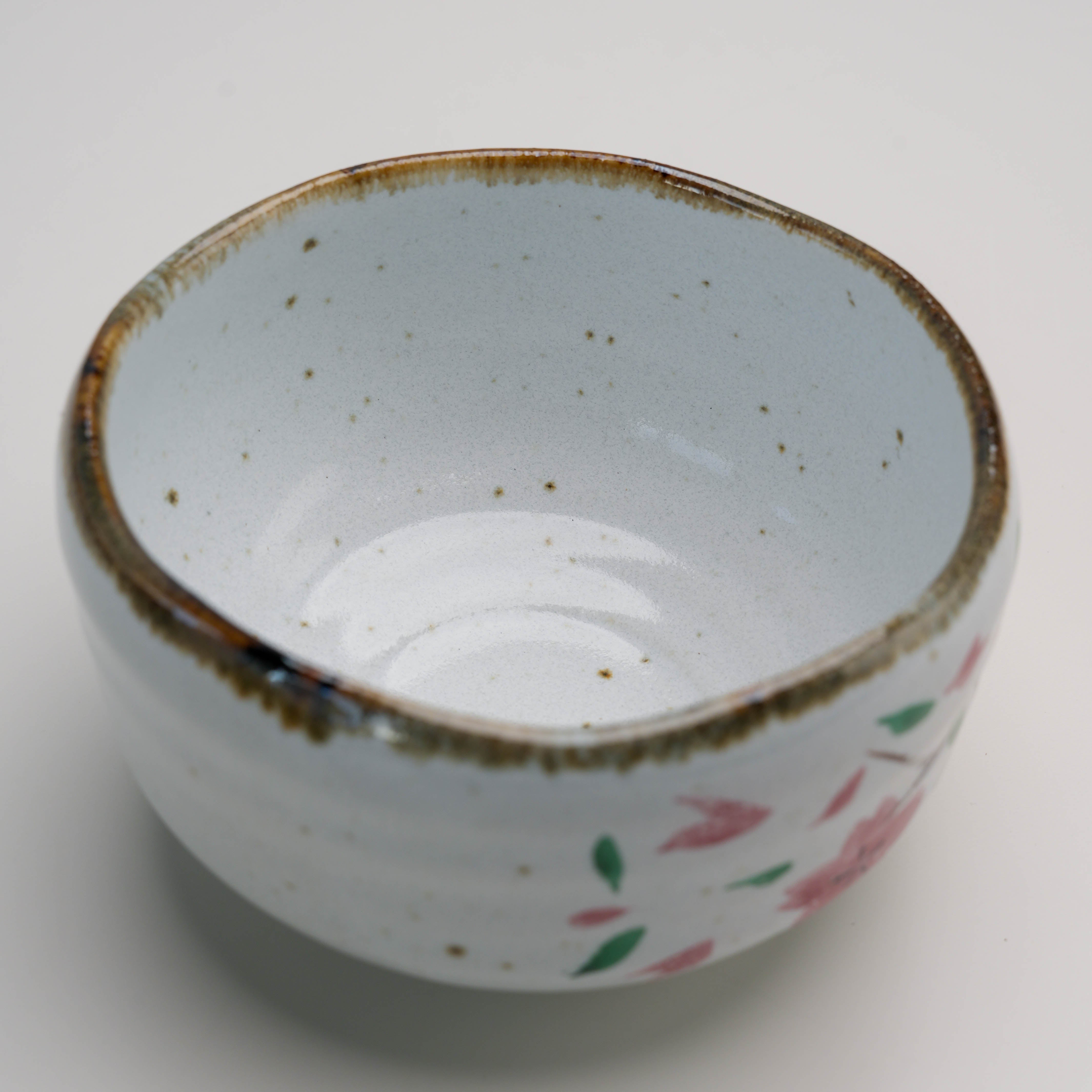 Top view of Mino Ware Cherry Blossom Matcha Bowl showcasing speckled glaze and organic rim, perfect for elegant tea rituals.
