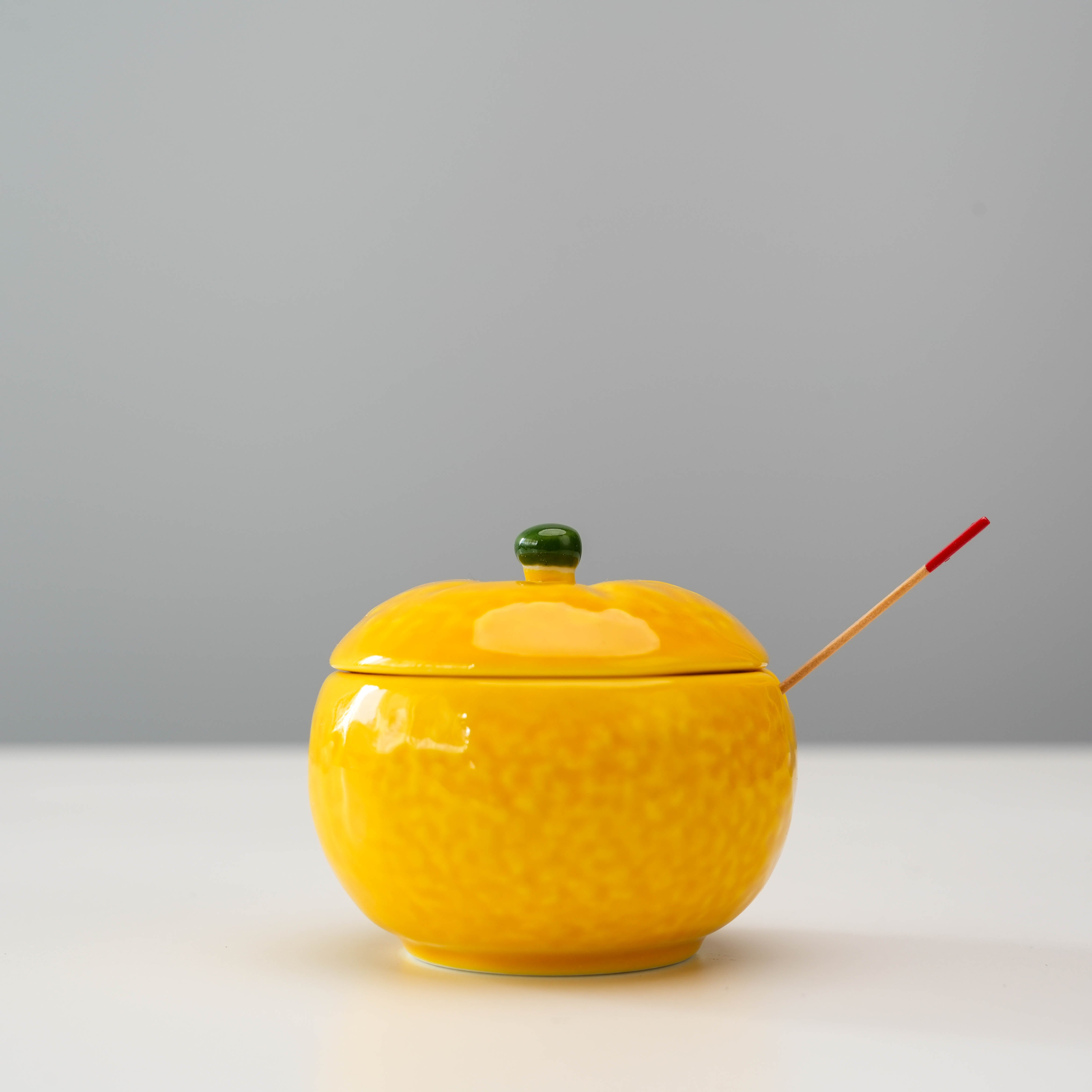 Arita Ware Condiment Container - Yuzu Design with lid and red-tipped spoon, ideal for spices or sauces in kitchen or dining settings.