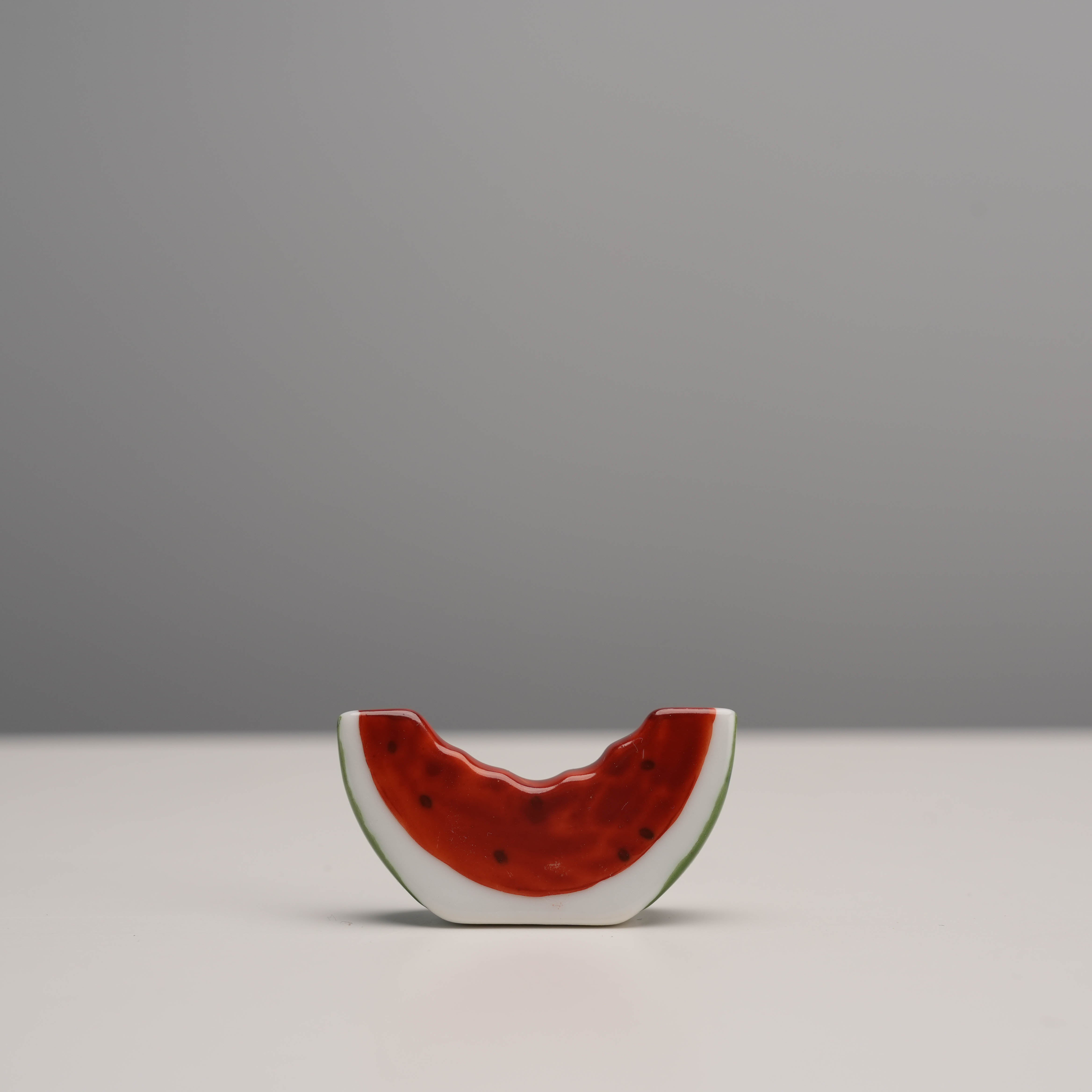 Close-up of Arita Ware Watermelon Chopstick Rest with realistic glaze, perfect for adding seasonal charm to kitchen and dining tableware.