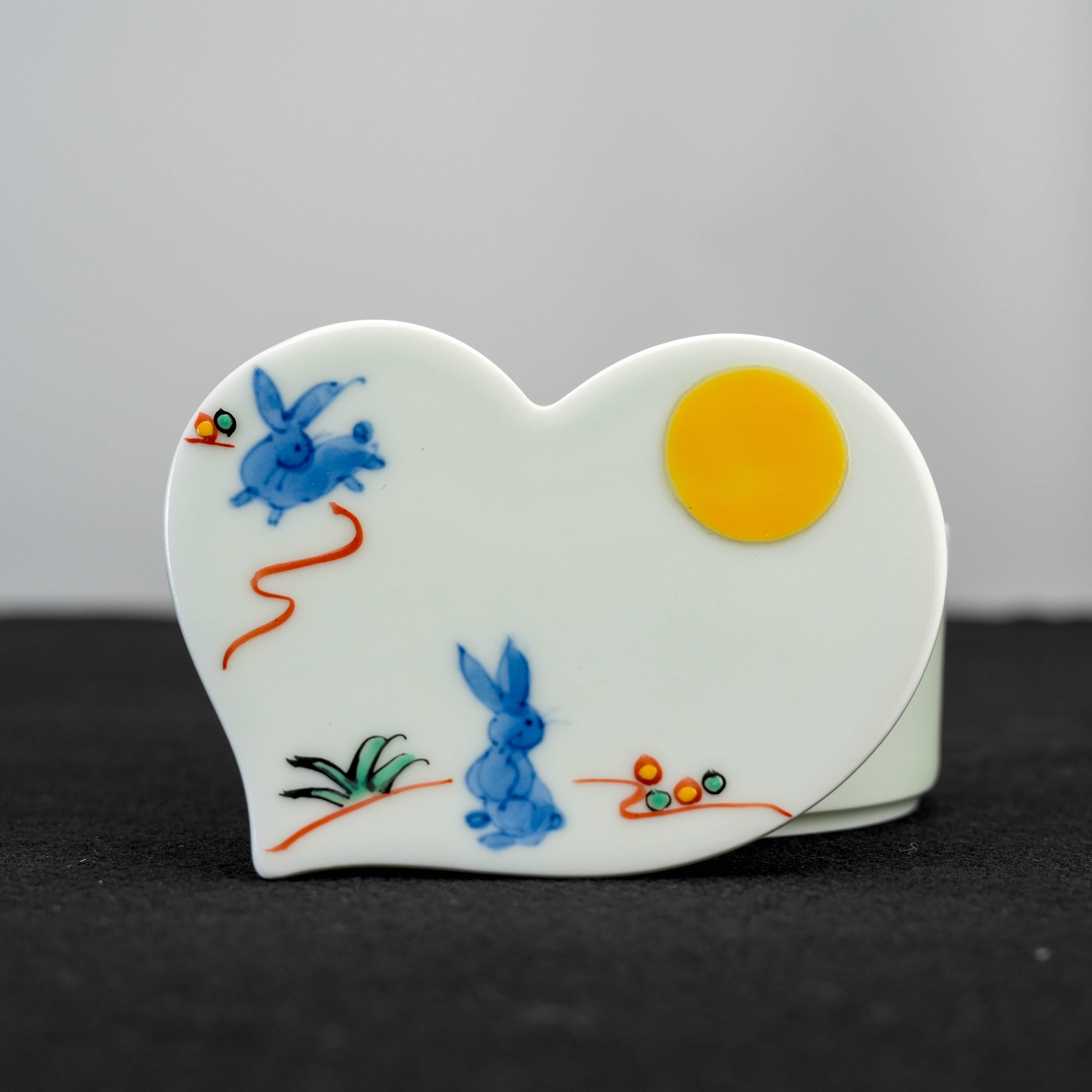 Close-up of Arita Ware Moon Rabbit Trinket Box - Keepsake Holder | Japanese Porcelain featuring playful blue rabbits and golden moon on white ceramic lid.