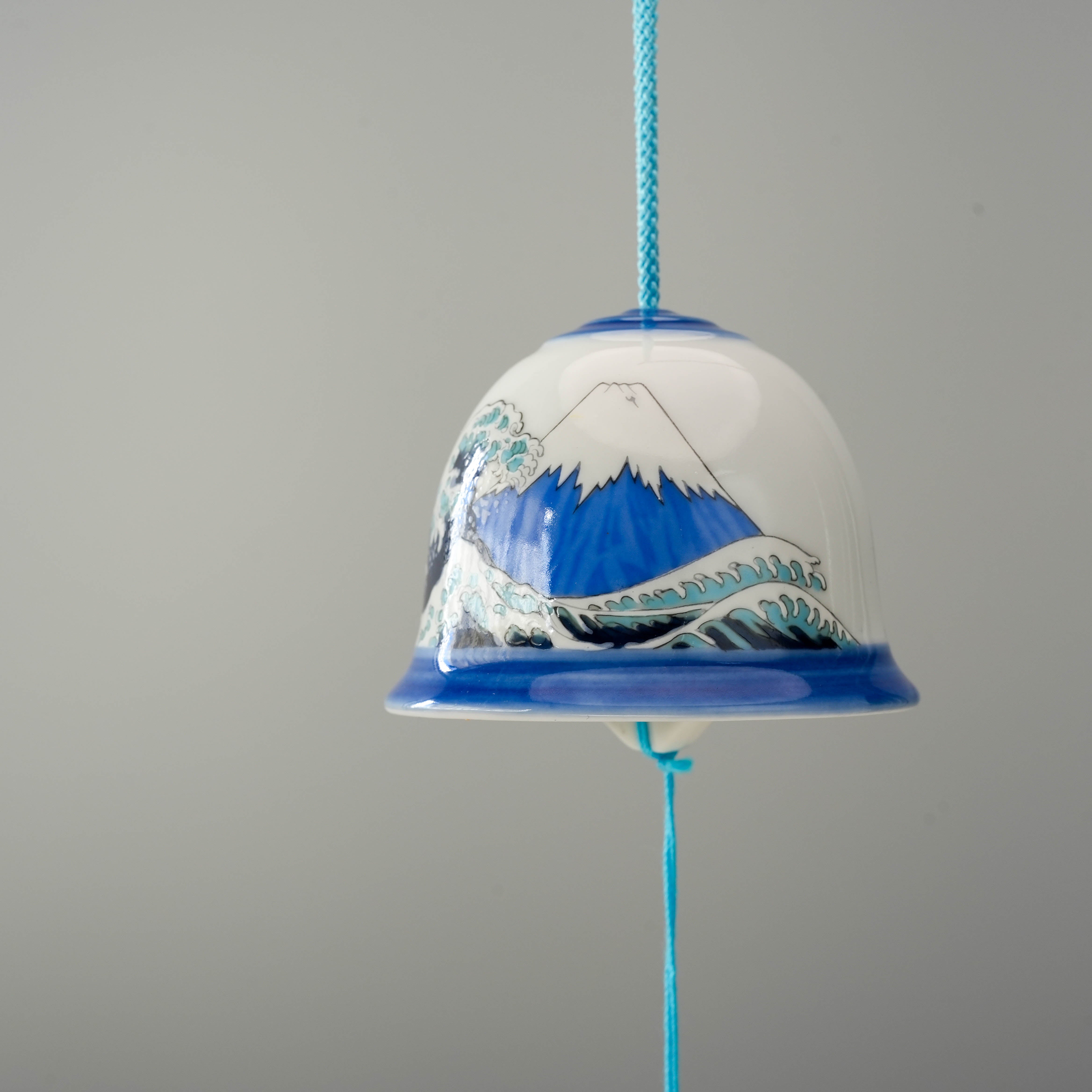Close-up of Arita Ware Wave Wind Chime - Fuji Mt, highlighting intricate hand-painted Mt. Fuji and wave artwork on fine Japanese porcelain.
