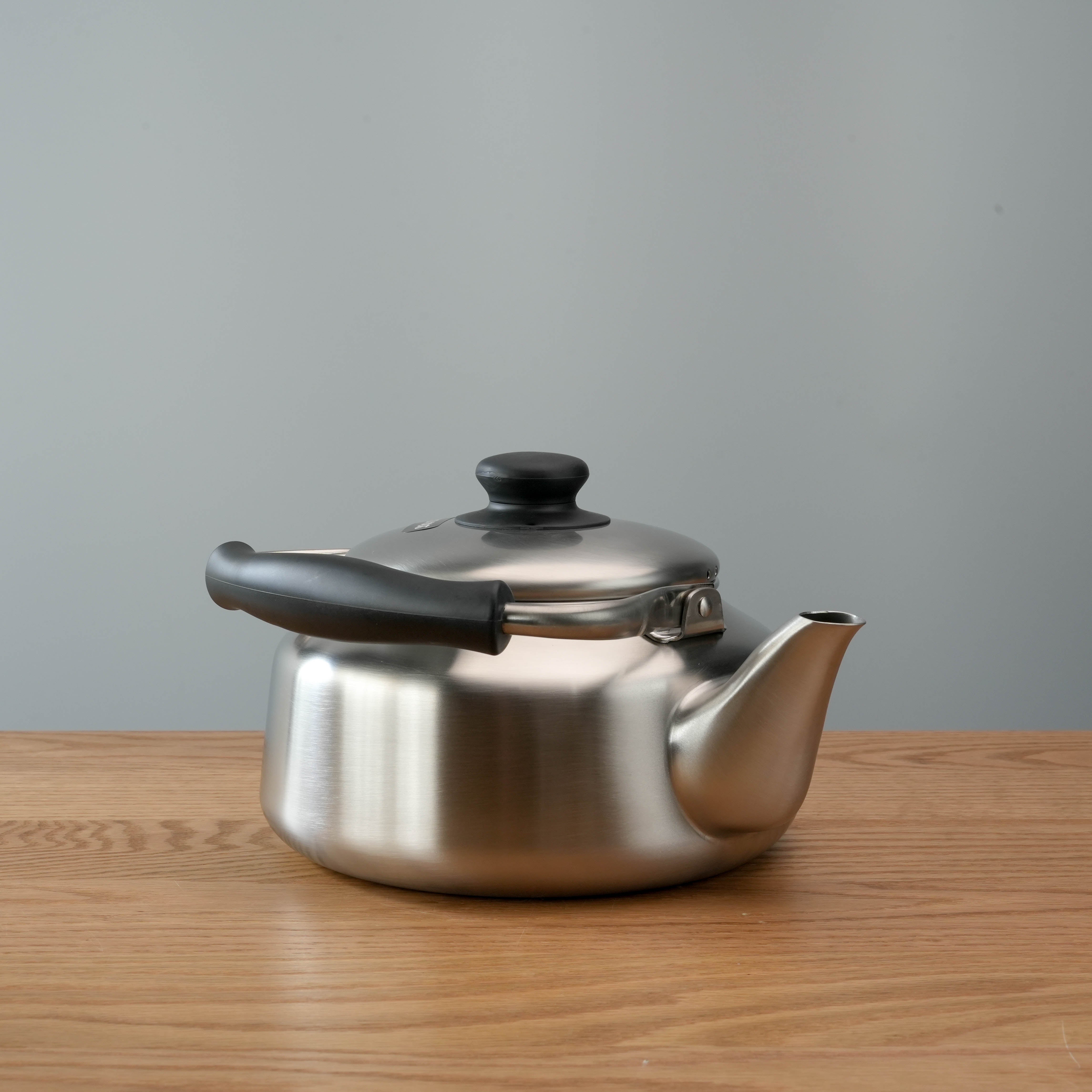Low-profile Sori Yanagi Stainless Steel Kettle with ergonomic black handle and precision spout, perfect for stovetop use.