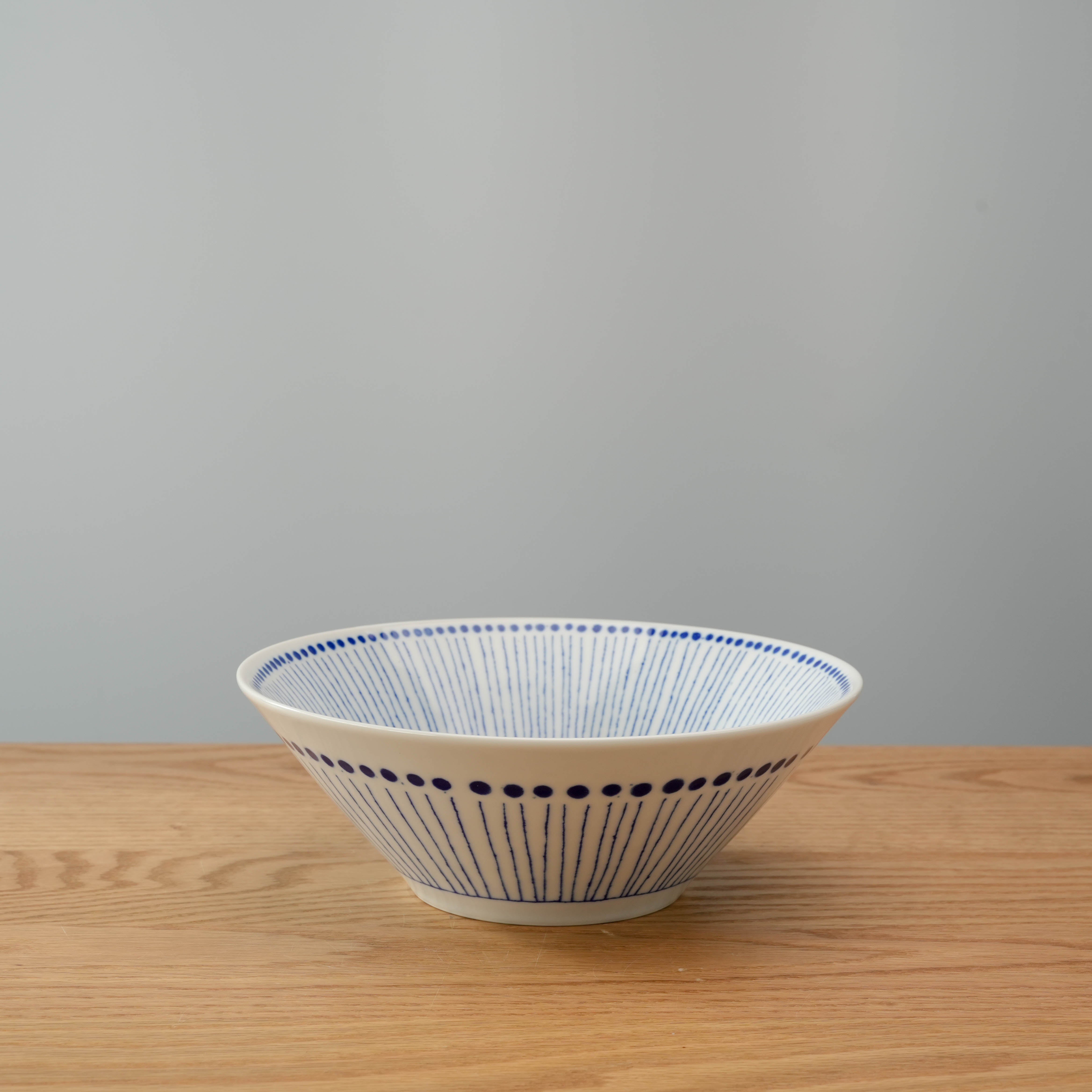 Side view of Mino Ware Blue Tokusa Dot Bowl, highlighting its flared shape and traditional Japanese design for noodle dishes.