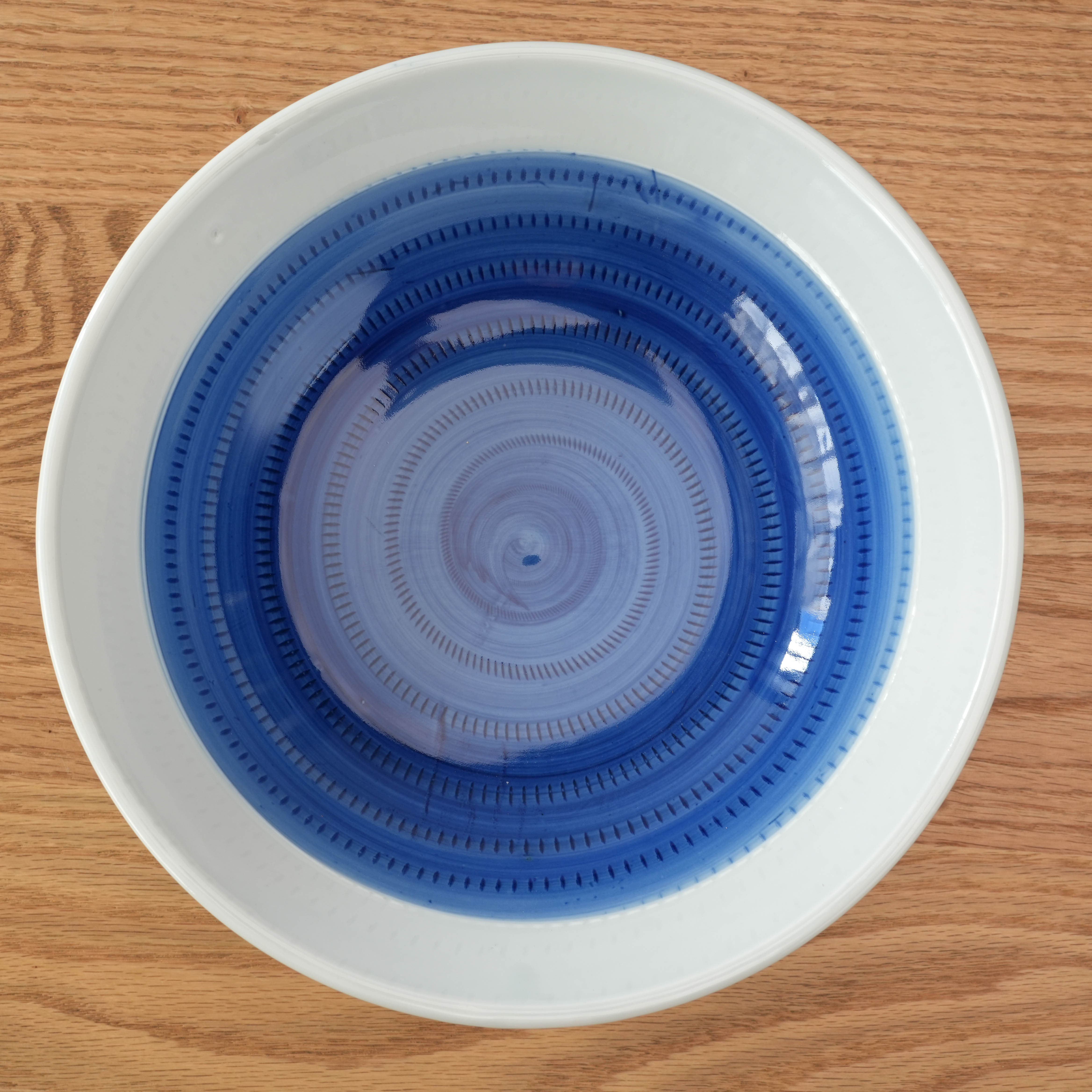 Top-down view of Mino Ware Tochiri Donburi Bowl with concentric blue brush strokes, ideal for stylish Japanese table settings.