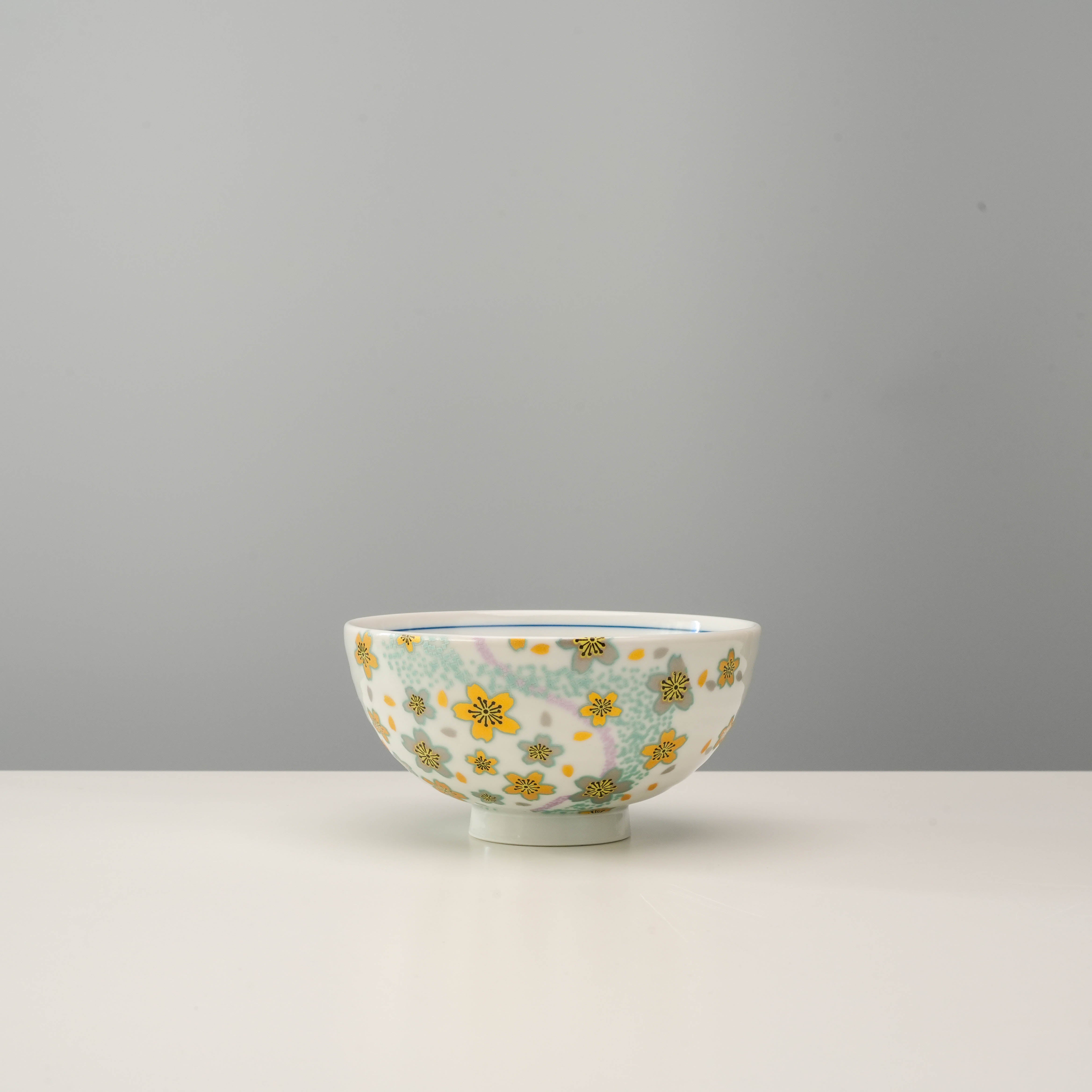 Single Kutani Ware rice bowl from the Kyokusui Flower Set with yellow and green floral design, part of a charming pastel dinnerware gift.