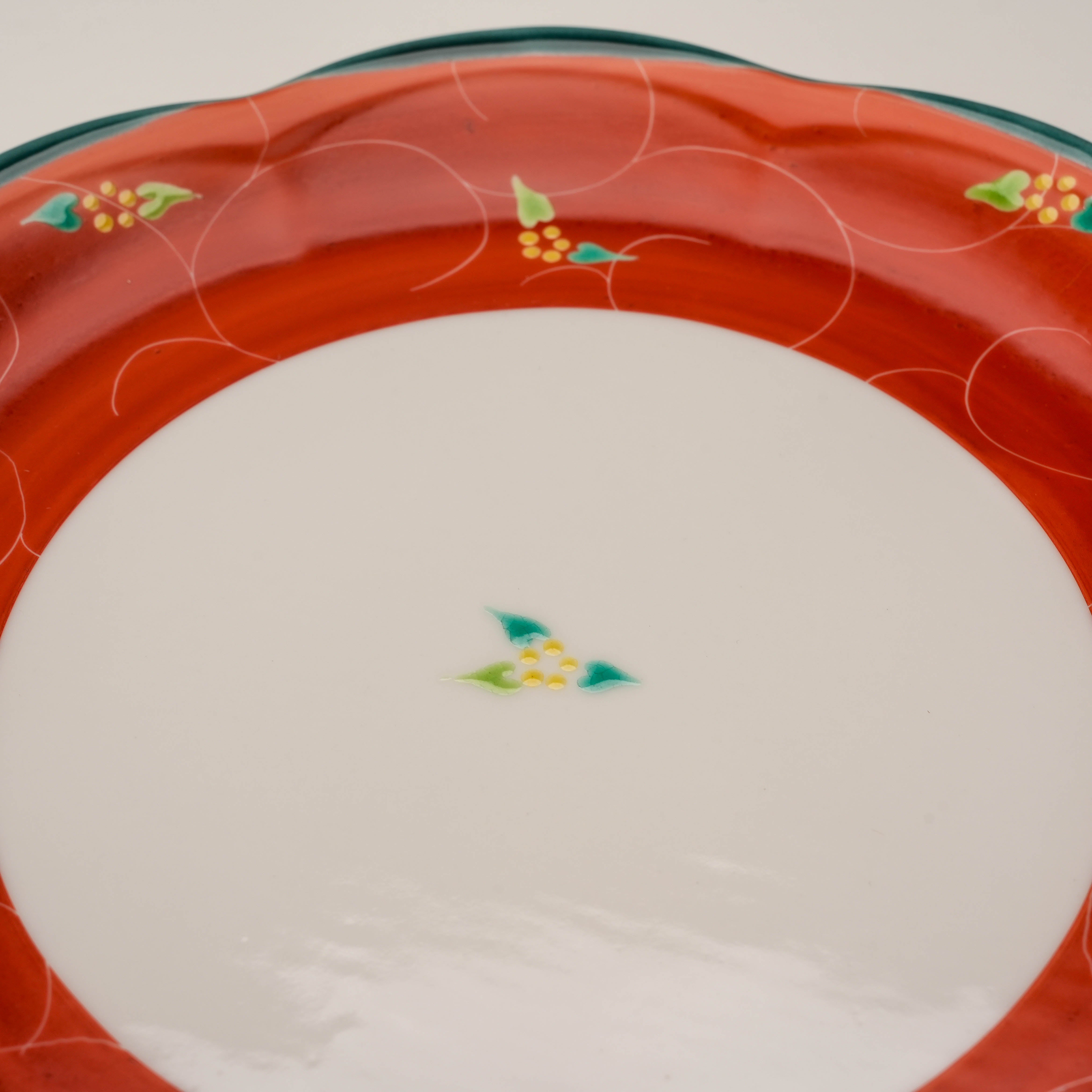 Center view of Kutani Ware Plate - Vermilion Arabesque showing delicate green and yellow floral design on a white base.