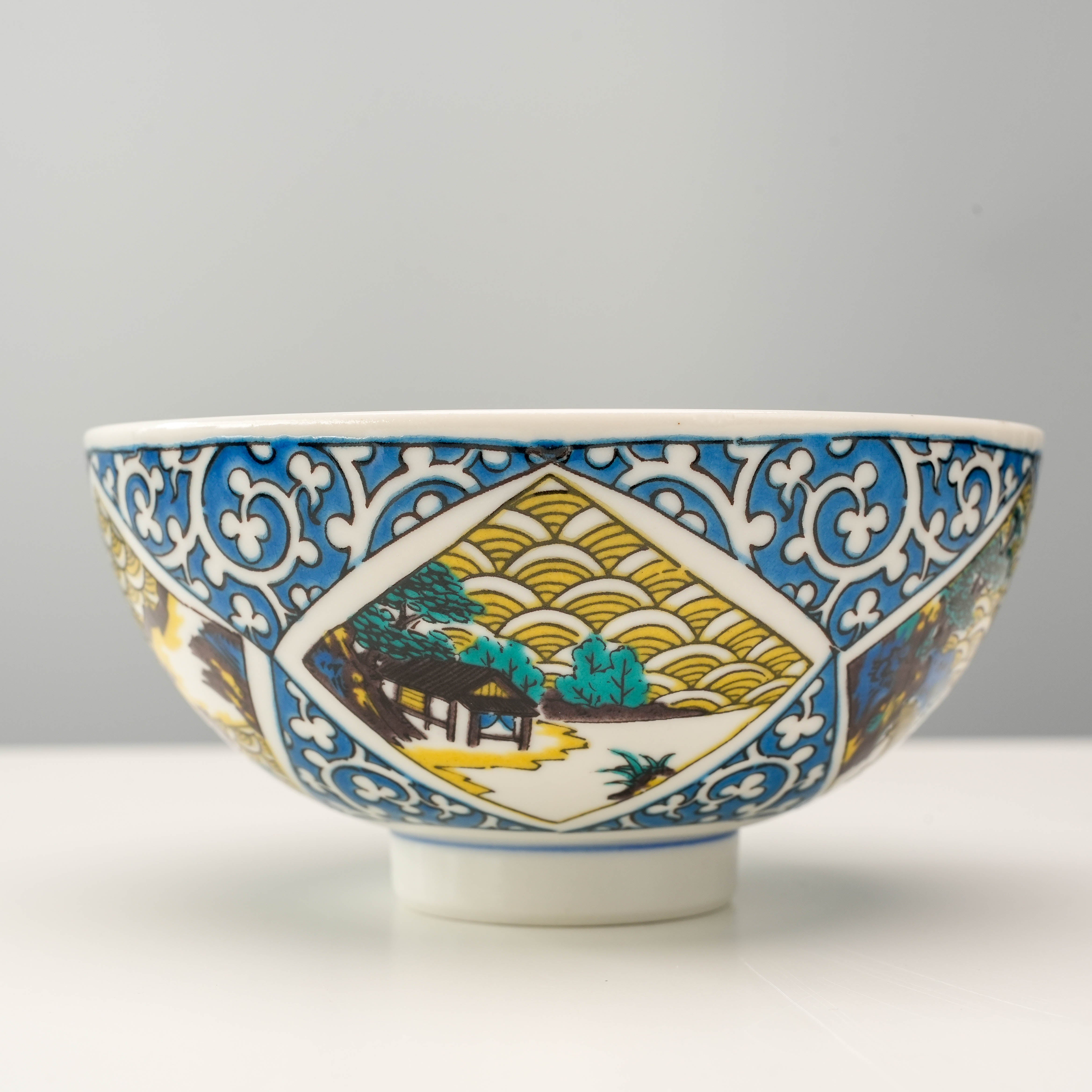 Kutani Ware Rice Bowl with vivid landscape and arabesque motifs, perfect for enhancing Japanese tableware collections in kitchen and dining settings.