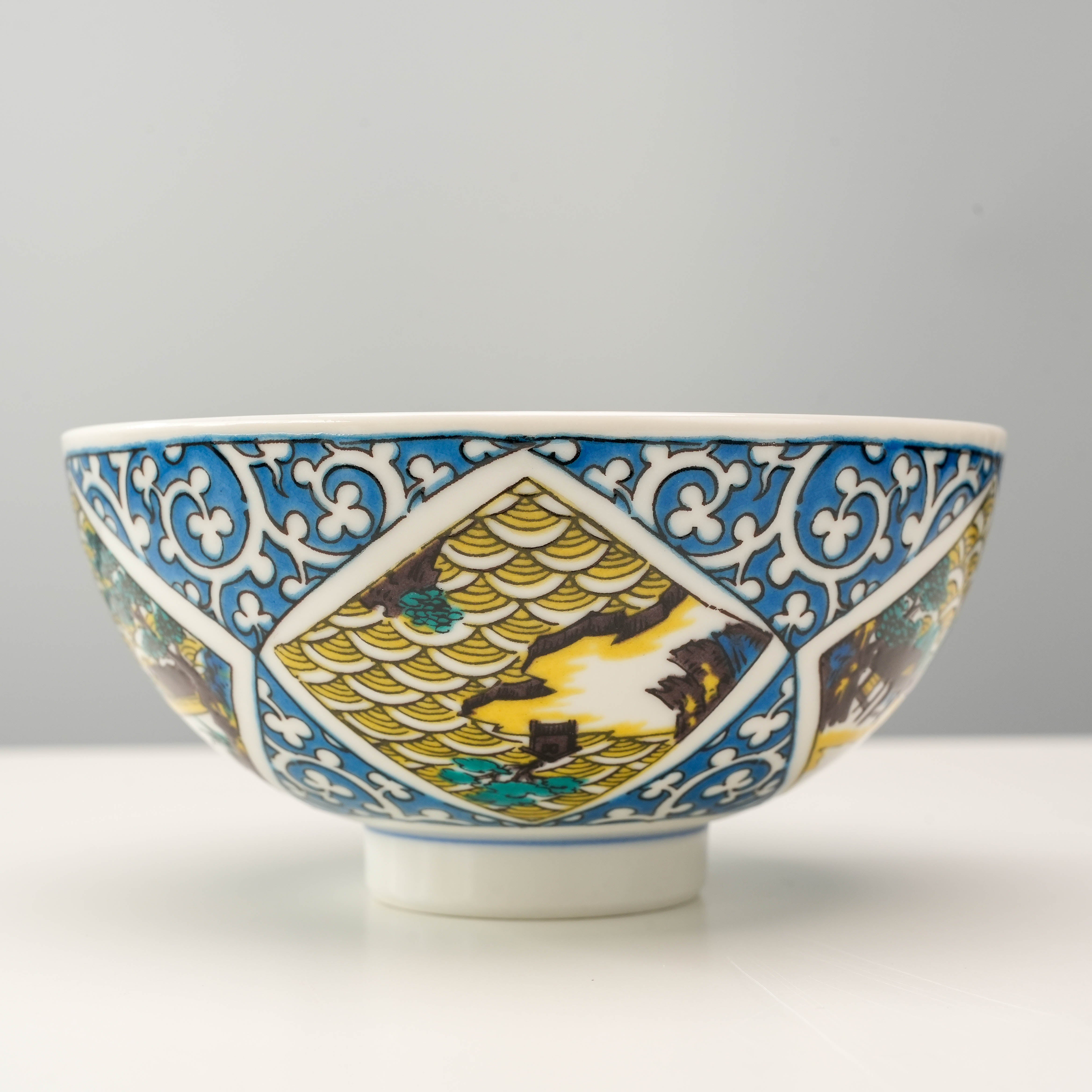 Elegant Kutani Ware Rice Bowl featuring golden wave patterns and scenic artwork, ideal for serving rice with a touch of traditional Japanese style.